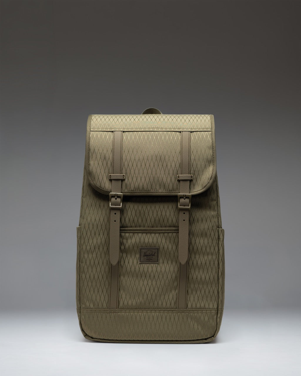 Herschel Supply Co. Retreat Backpack in Ivy Green Diamond with a drawcord closure and magnetic strap detailed top flap.
