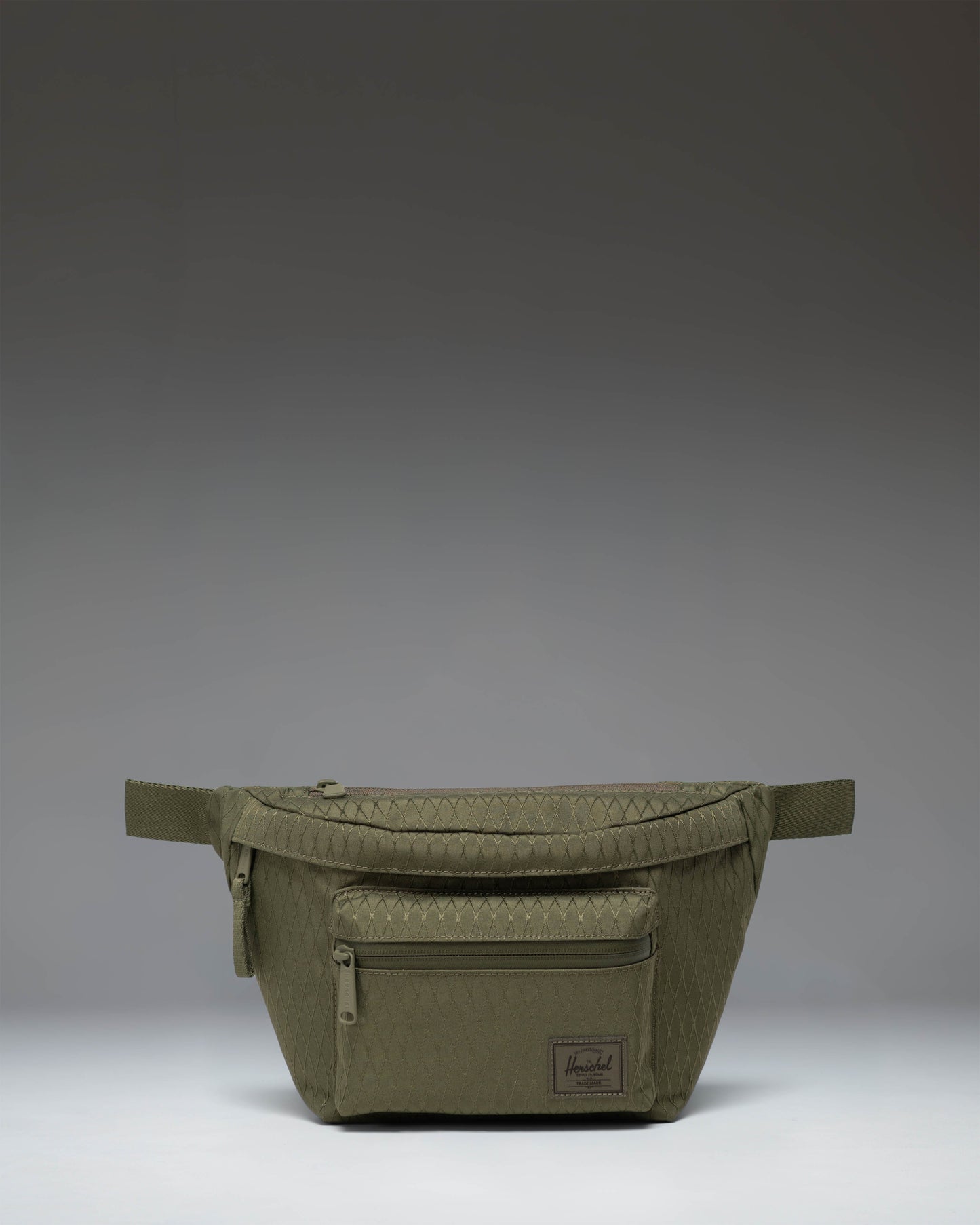 Herschel Supply Co. Pop Quiz Hip Pack in Ivy Green Diamond featuring a textured diamond pattern, front pocket, and adjustable strap.