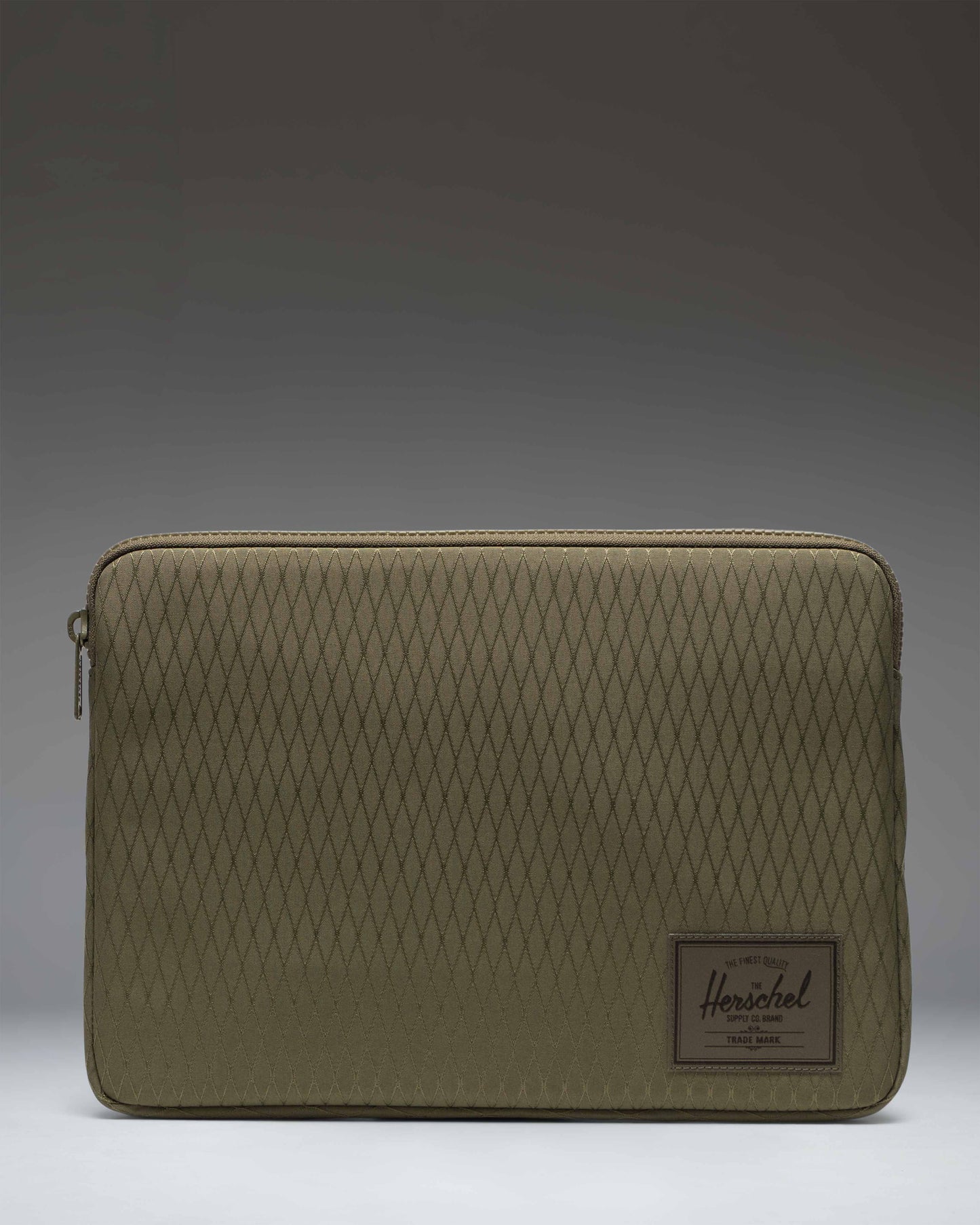Herschel Supply Co. Anchor 14 Inch Sleeve in Ivy Green Diamond pattern featuring a clean minimal design with a classic brand logo.