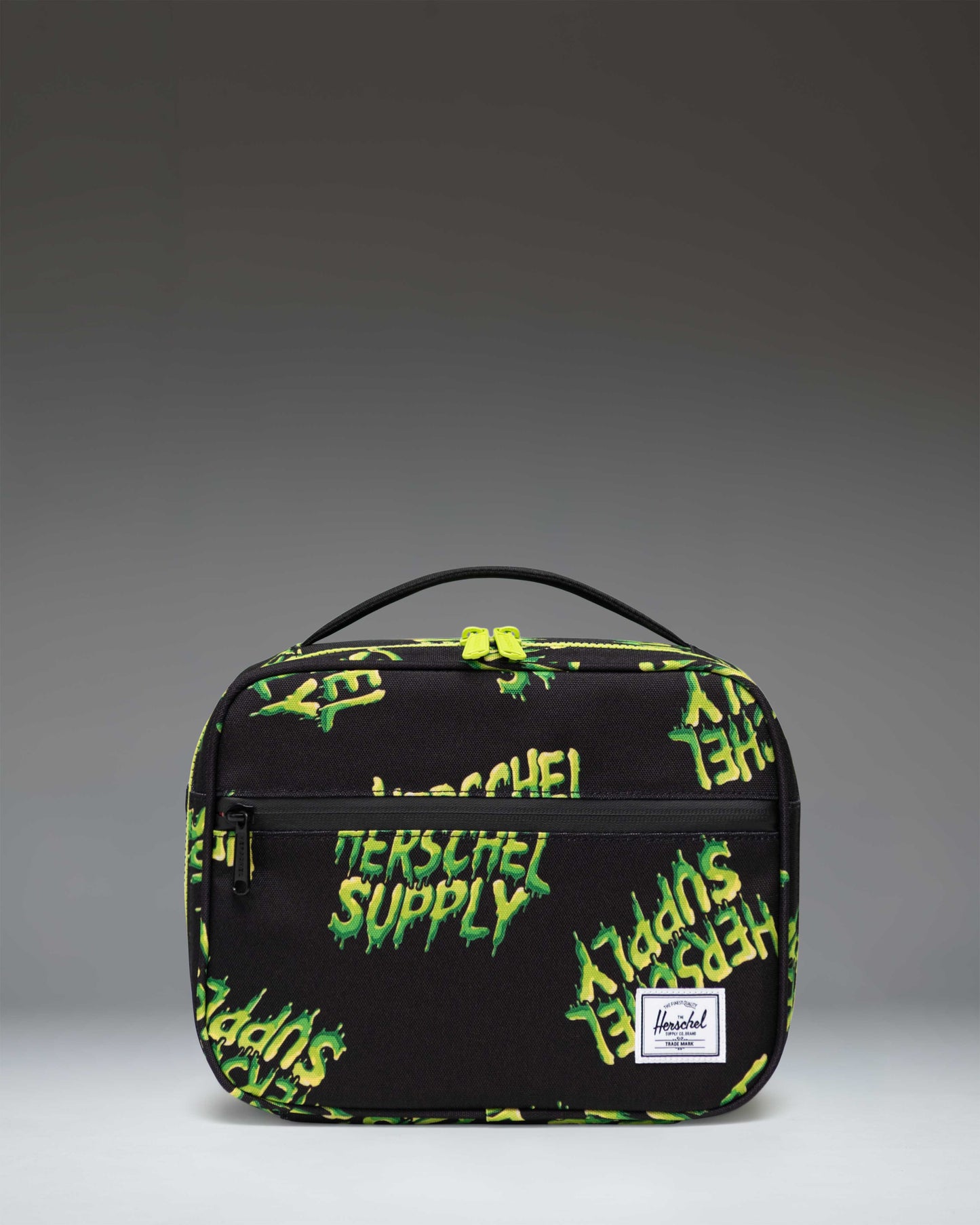 Little Herschel Pop Quiz Lunch Box in HSC Slime green, showcasing a zippered front pocket and classic woven label on a clean white background.