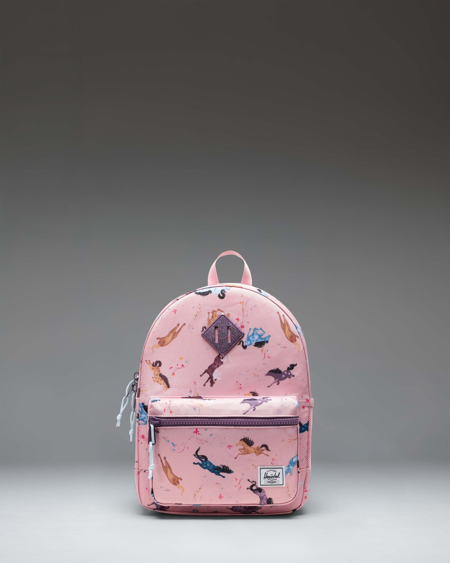 Herschel Heritage Kids Backpack in Wild Horses, featuring a brown horse pattern on a blue background with a brown diamond accent.