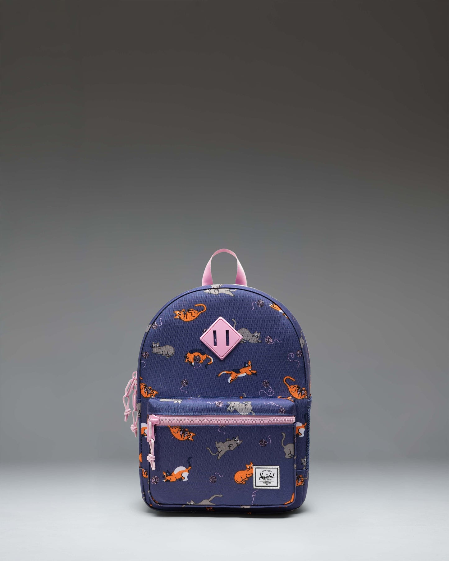 Herschel Heritage Kids Backpack in Playing Cats, a black backpack with a whimsical playing cats pattern, front pocket, and classic diamond detail.