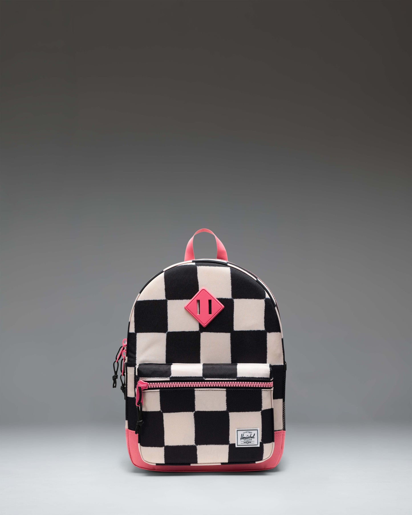 Herschel Heritage Kids Backpack in Check This Confetti, a colorful confetti pattern over a checkered background.