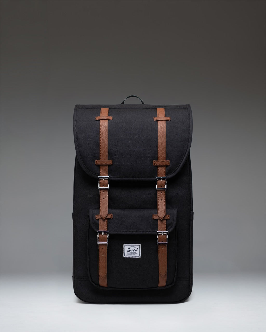 Herschel Supply Co. Little America Backpack in black, featuring a classic mountaineering style with dual rubber straps and a front pocket.