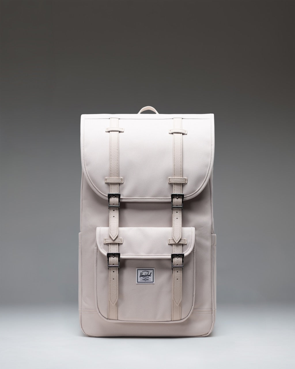 Herschel Little America Backpack in Moonbeam, a light beige everyday backpack with dual brown rubber straps and front pocket.