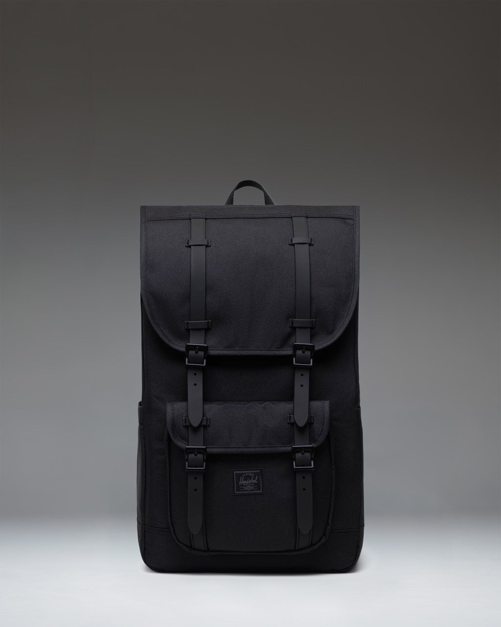 Herschel Little America Backpack in Black Tonal with black straps and front storage pocket.