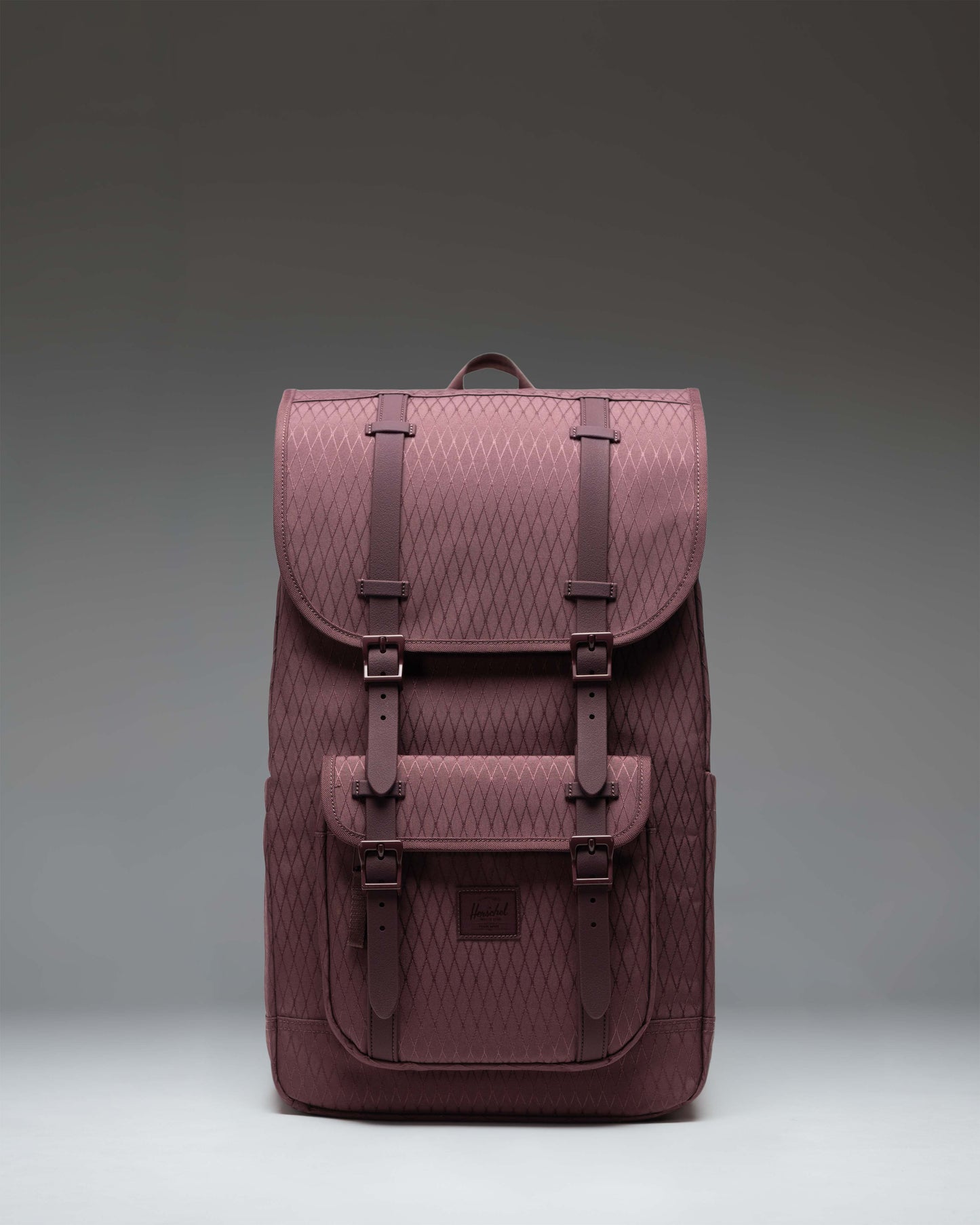 Herschel Little America Backpack in Huckleberry Diamond, featuring a purple checkered pattern with front rubber strap closures.