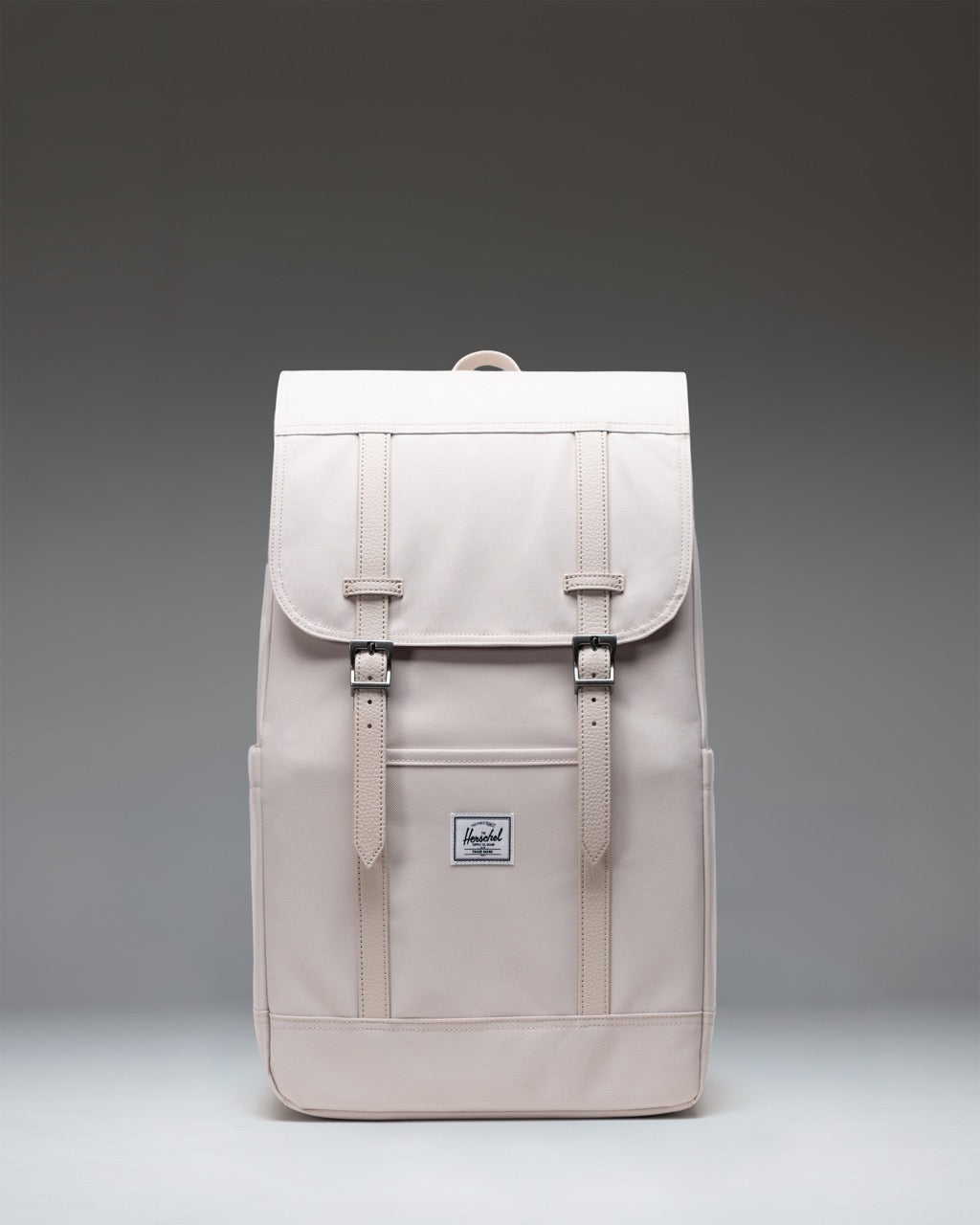 Herschel Retreat Backpack 23L in Moonbeam creme-white color with magnetic strap closures and dual water bottle pockets.