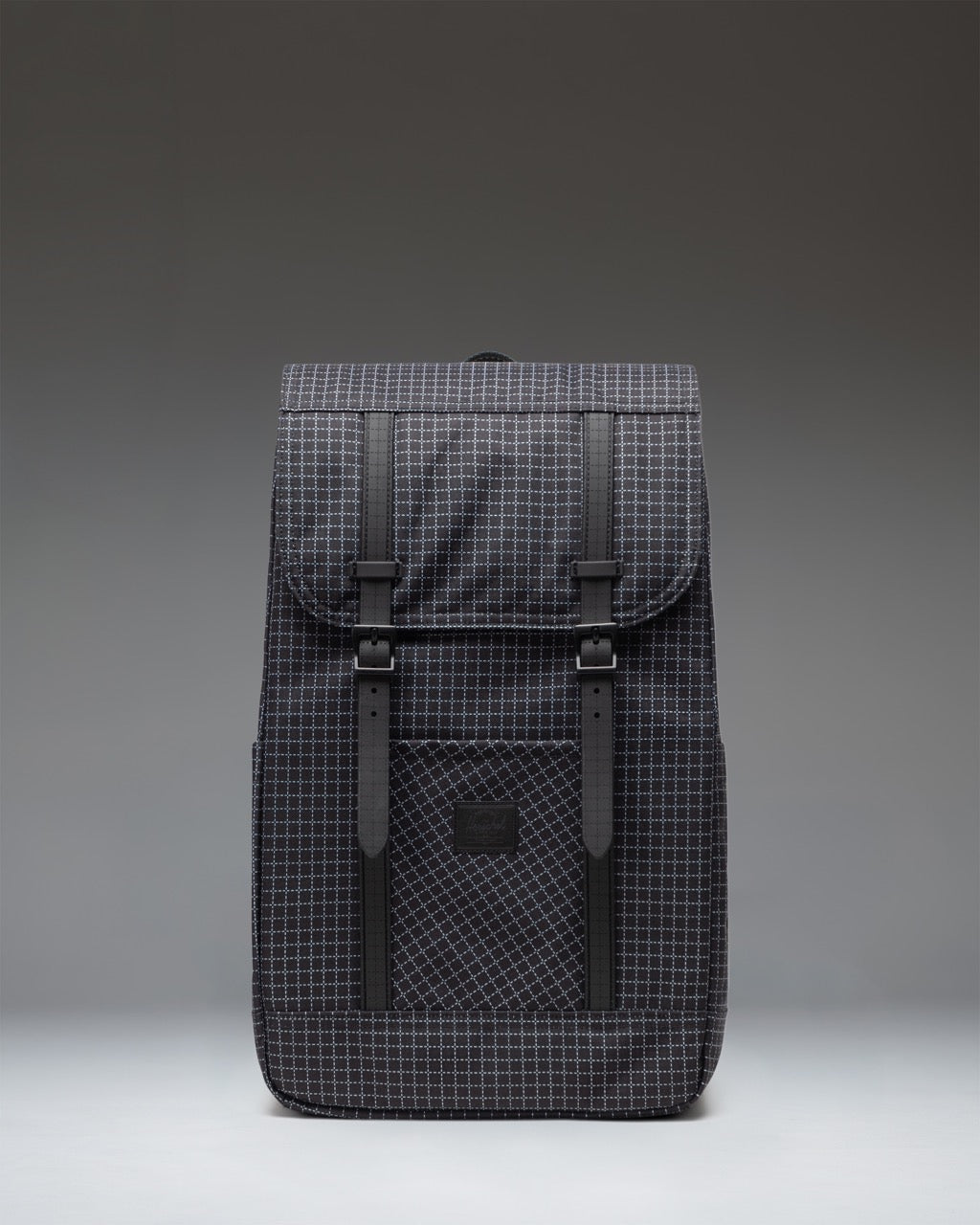 Herschel Retreat Backpack in Grid Black showing the front view with signature twin straps and a woven label.