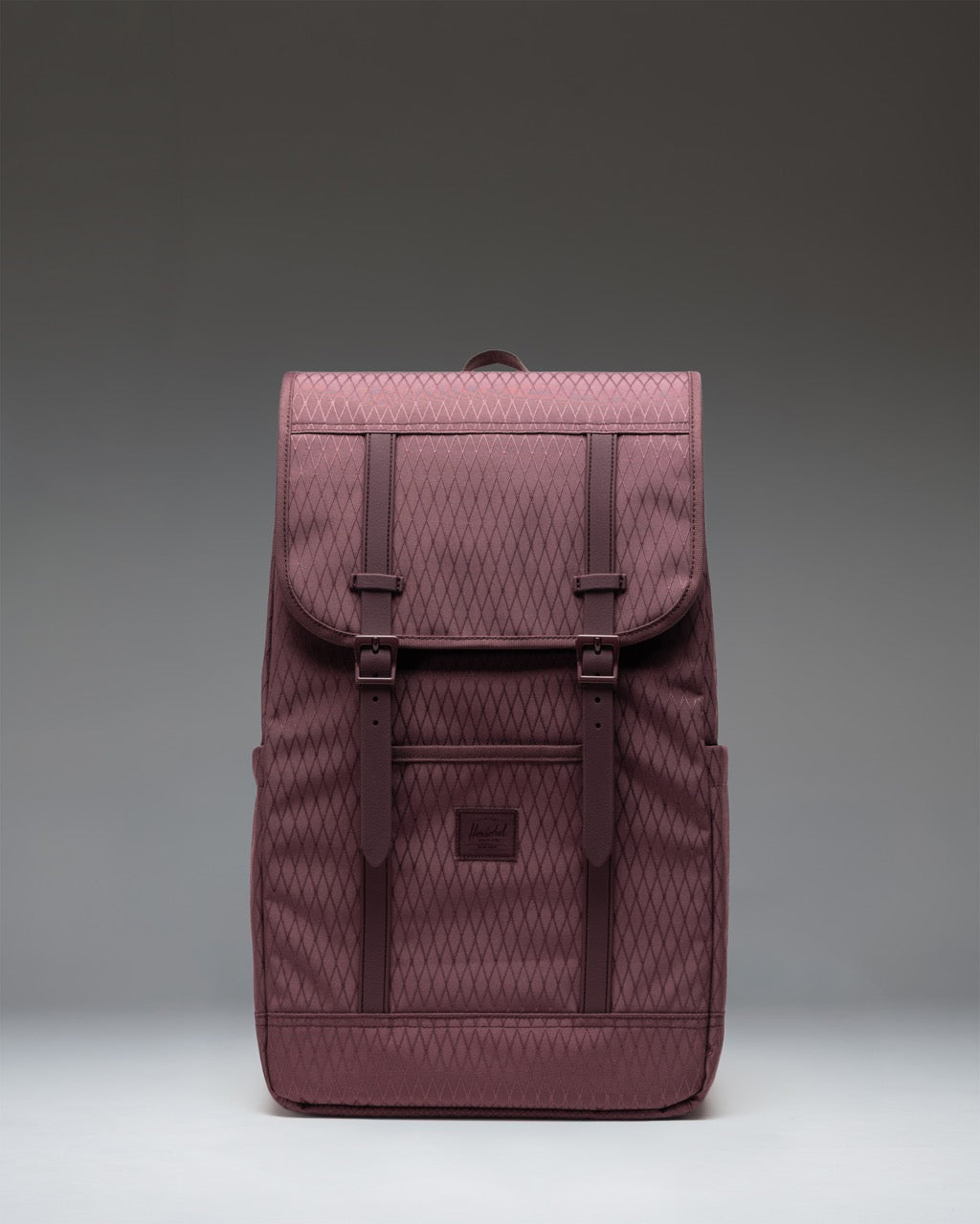 Herschel Retreat Backpack in Huckleberry Diamond, a deep purple and green diamond pattern, shown from the front.