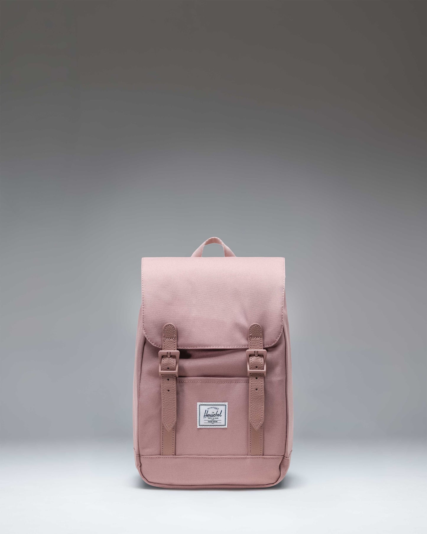 Herschel Retreat Mini Backpack in Ash Rose, a dusty pink color, featuring a drawstring closure and a single magnetic strap.