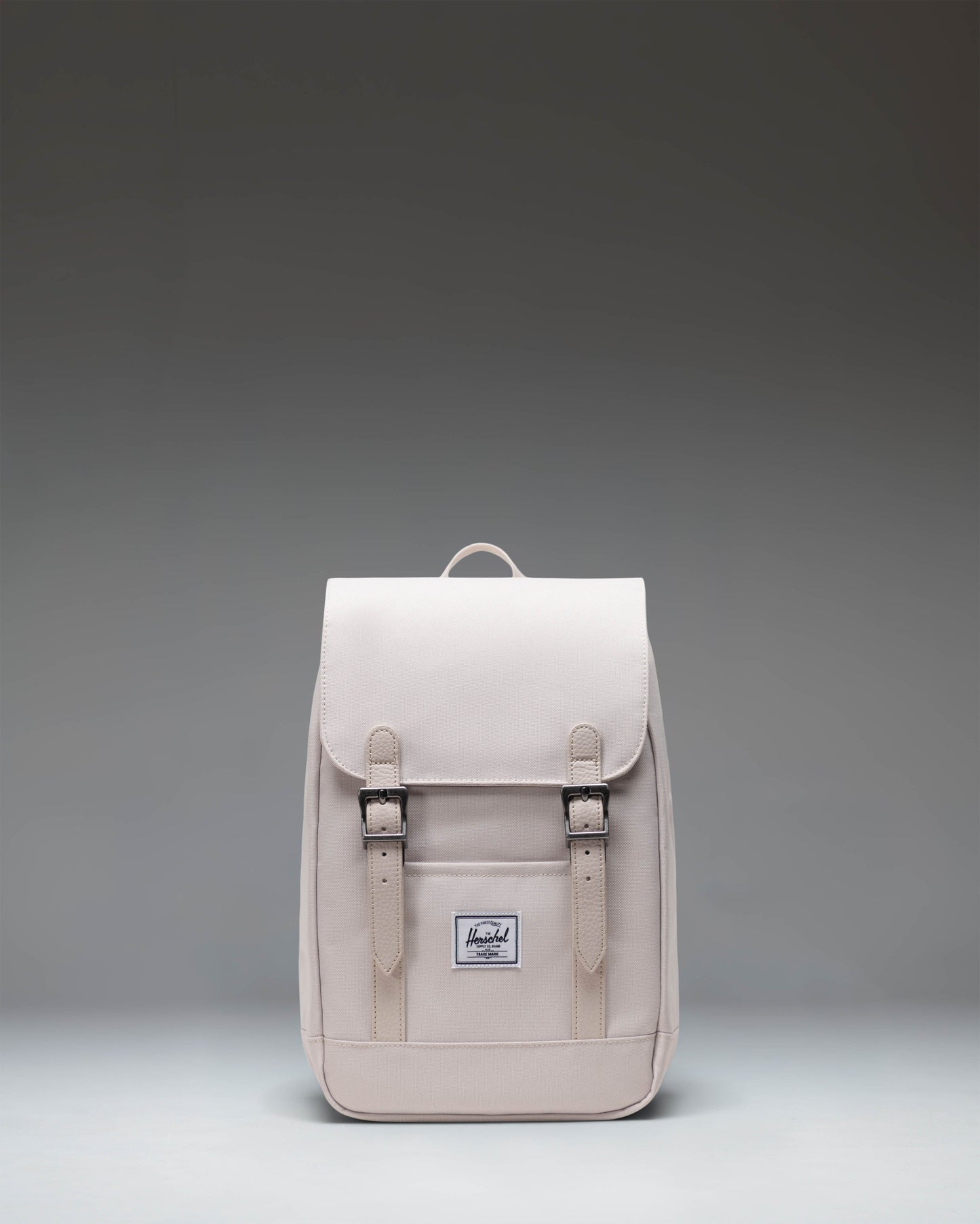 Herschel Retreat Mini Backpack in Moonbeam colorway, featuring a front storage sleeve and magnet fastened straps.