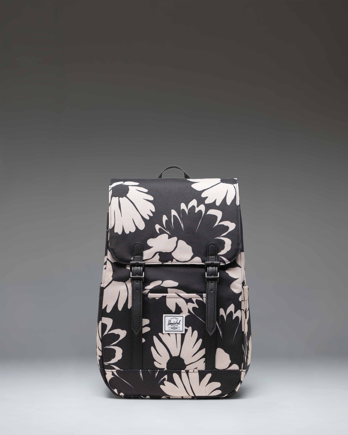 Herschel Retreat Small Backpack in Graphic Daisy - Moonbeam, featuring a floral print and front strap closures.