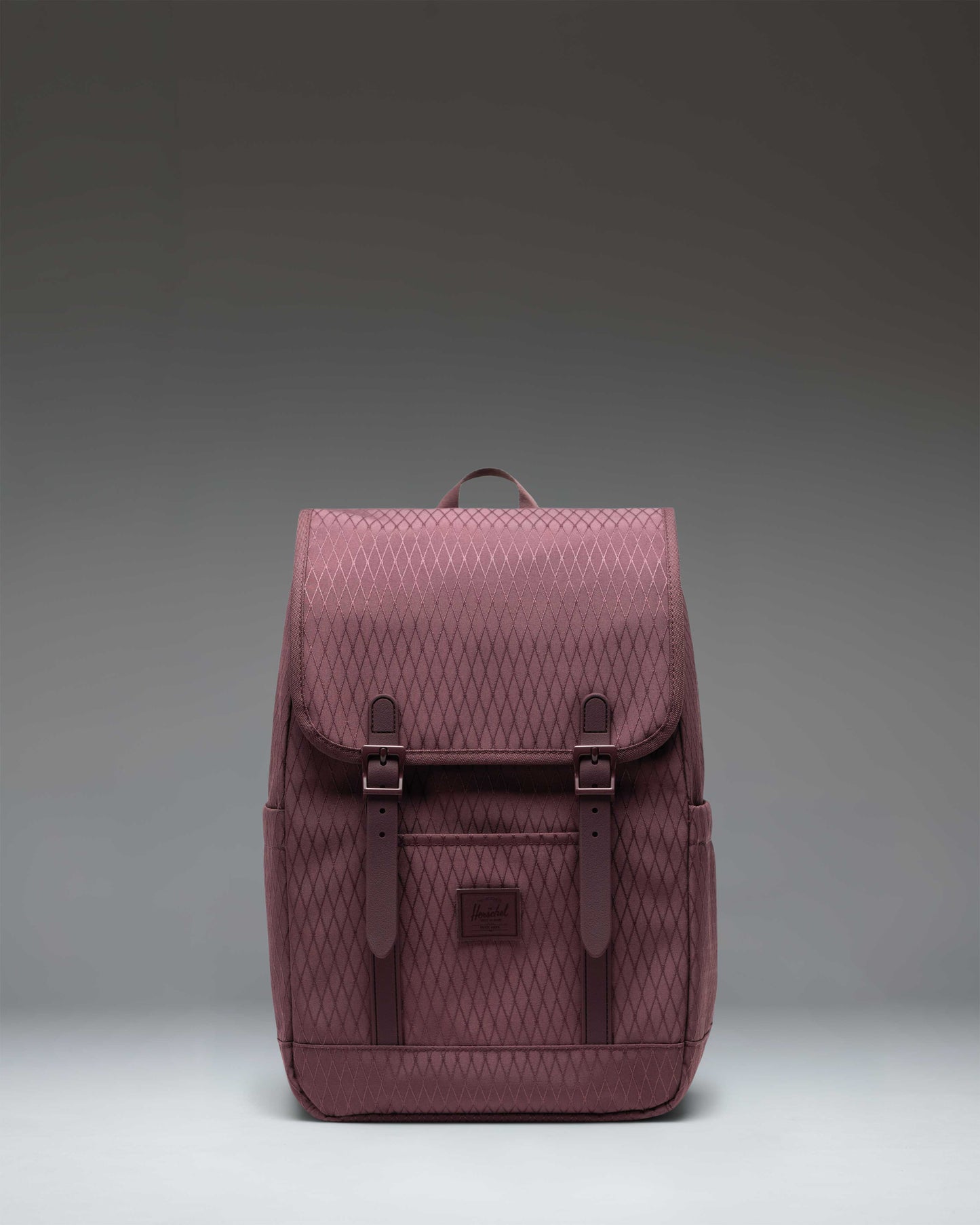Herschel Retreat Small Backpack in Huckleberry Diamond featuring a classic cinch top design and dual magnetic strap closures.