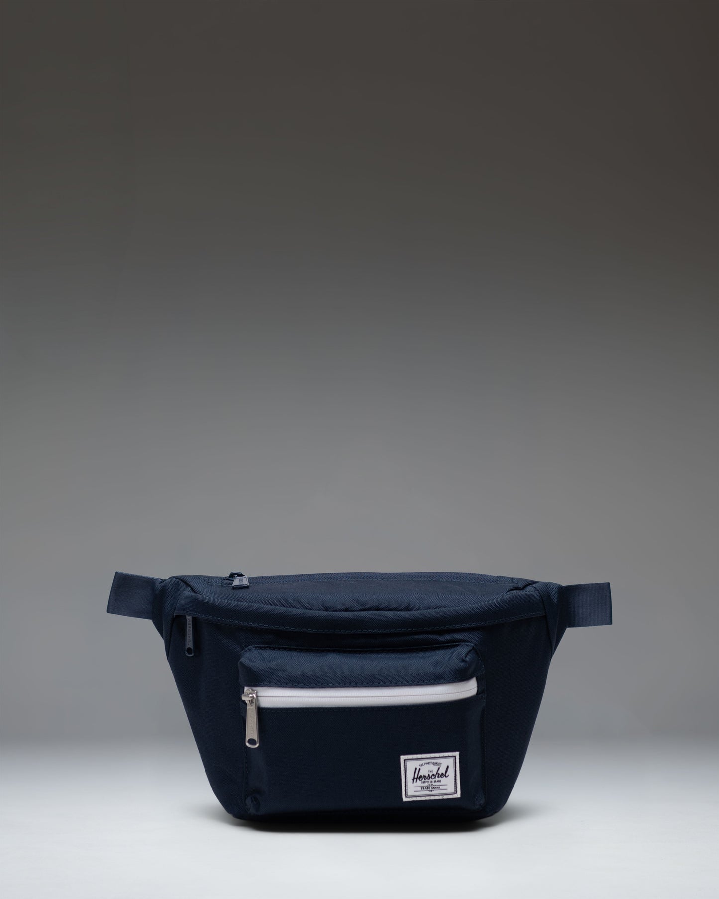 Herschel Supply Co. Pop Quiz Hip Pack in navy blue, showcasing its clean design, front pocket, and adjustable strap.