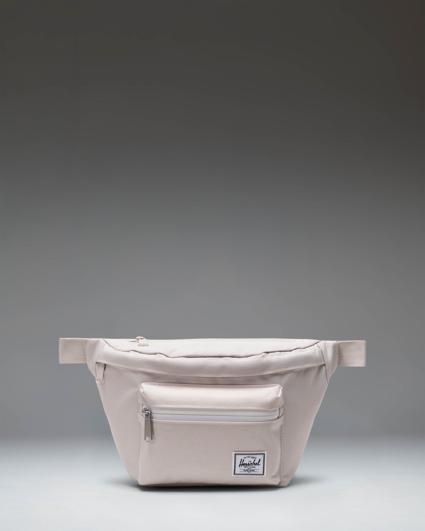Herschel Supply Co. Pop Quiz Hip Pack in Moonbeam beige, featuring a front zipper pocket and adjustable strap.
