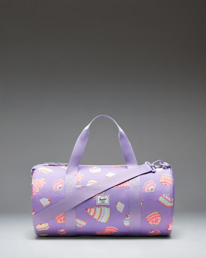 Herschel Classic Duffle Little Herschel in Cakes colorway, a pink kids' duffle bag featuring a colorful cake pattern.