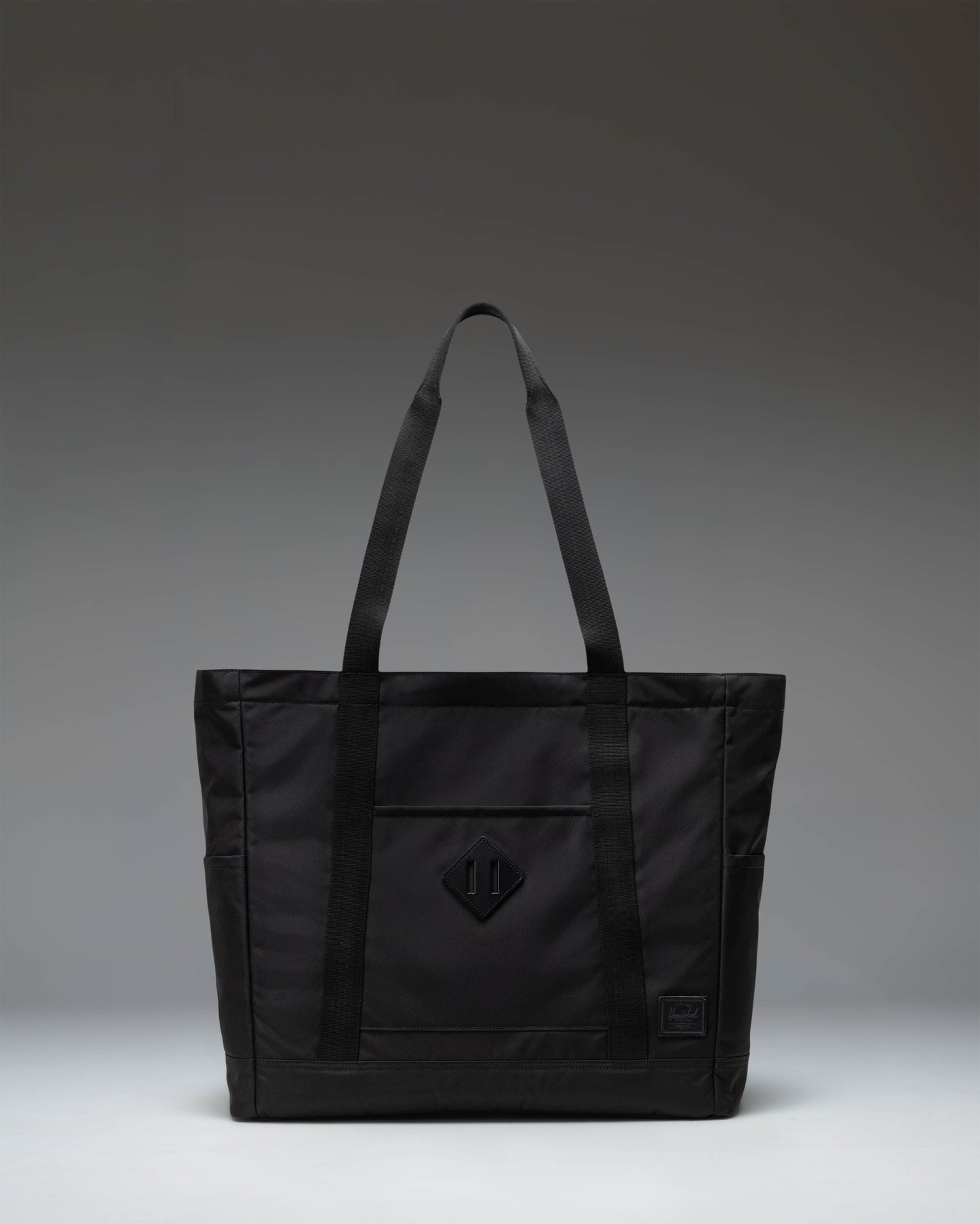 Herschel Heritage Tote bag in black, showcasing a classic design with dual top handles.