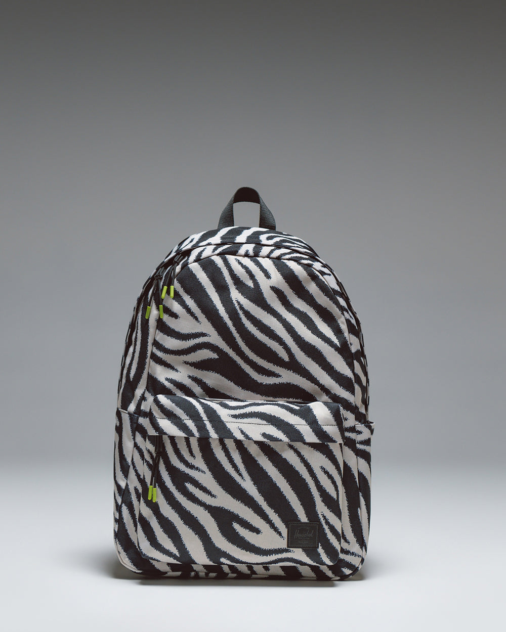 Herschel Classic XL Backpack in Zebra print, featuring a black and white zebra stripe pattern with a front storage pocket.