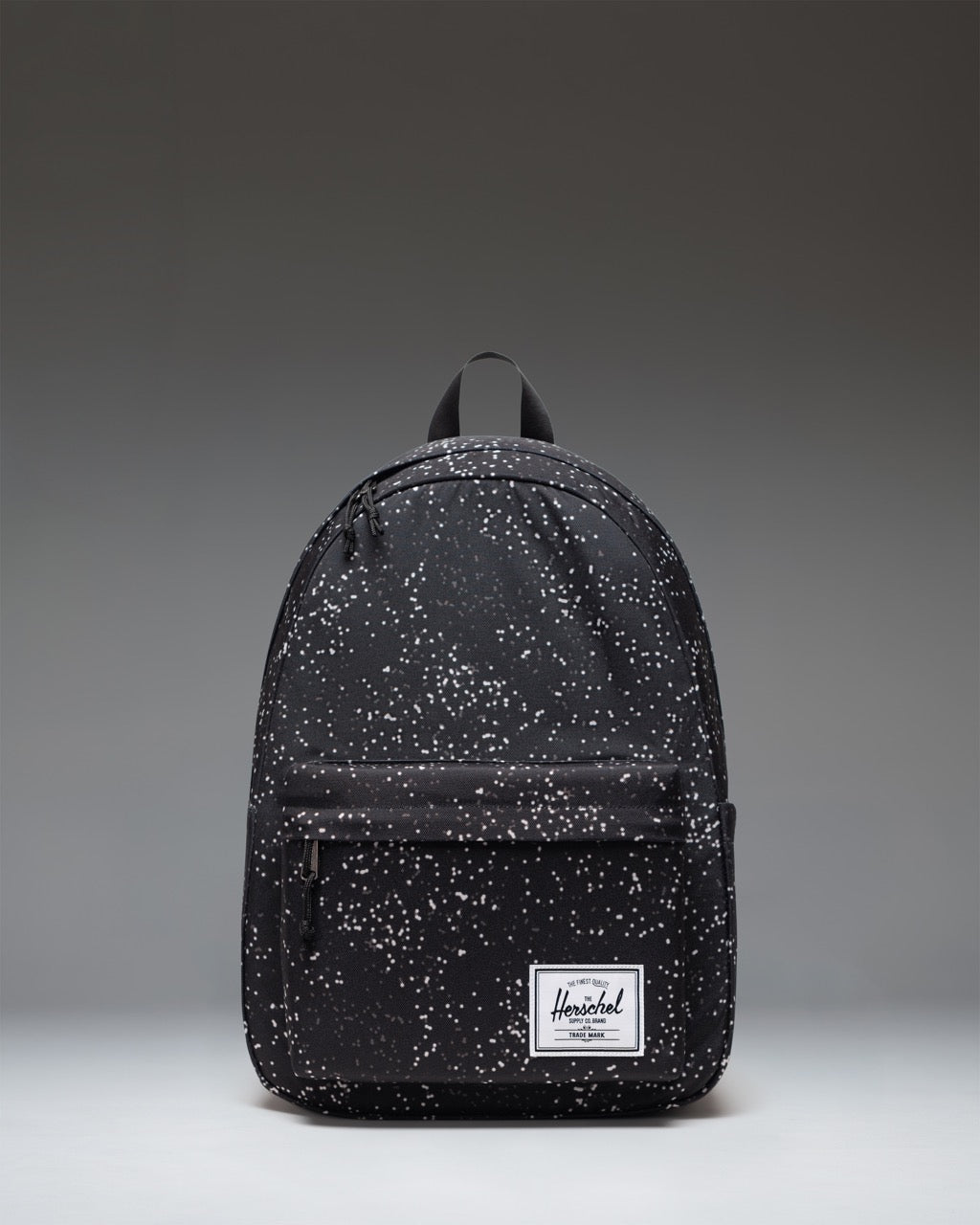 Herschel Supply Co. Classic XL Backpack in Blurred Dots pattern, featuring a black background with a scattered white pixelated dot design.