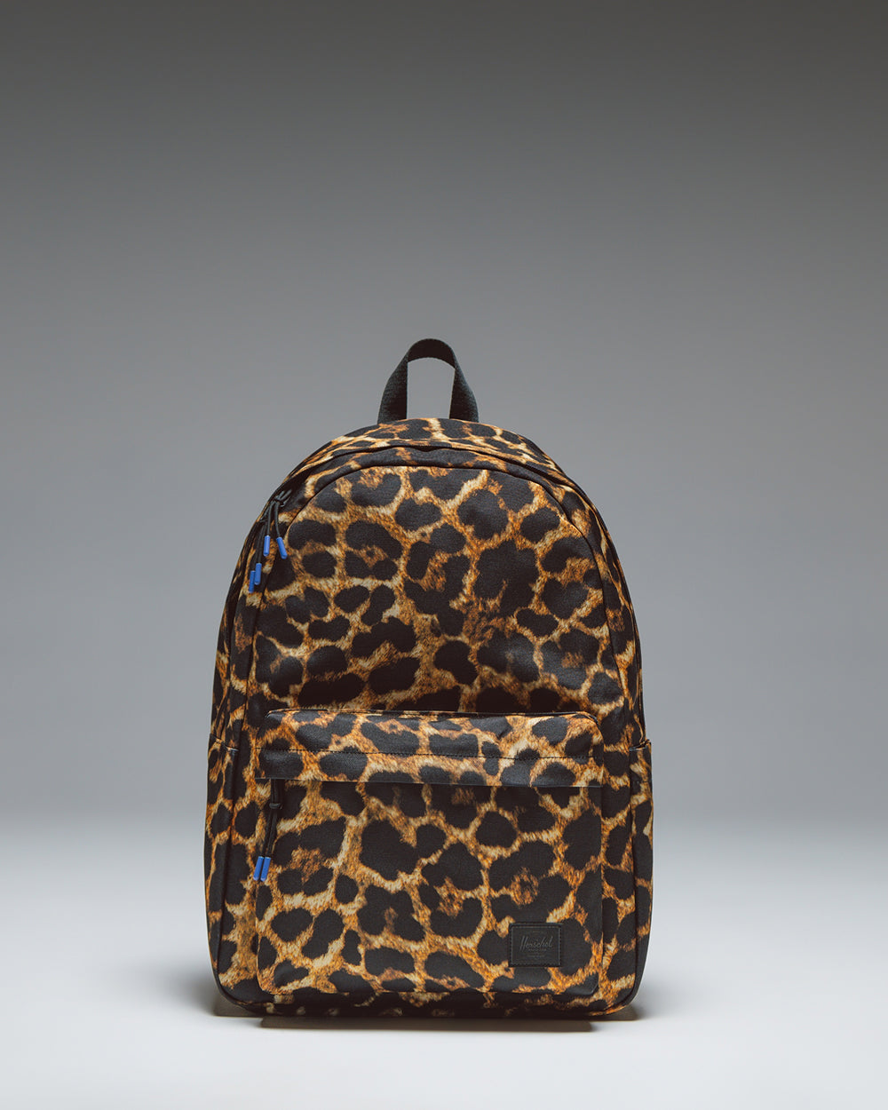 Herschel Classic XL Backpack in Digi Leopard Light print, showcasing the front zipper pocket, water bottle pocket, and adjustable shoulder straps.