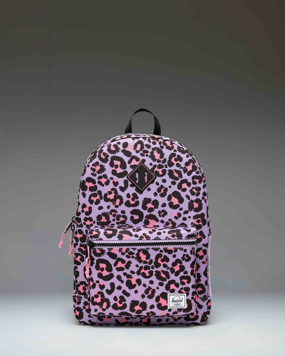 Herschel Heritage Youth Backpack in Scribble Leopard Sachet Pink featuring a playful leopard print pattern on a vibrant pink background.