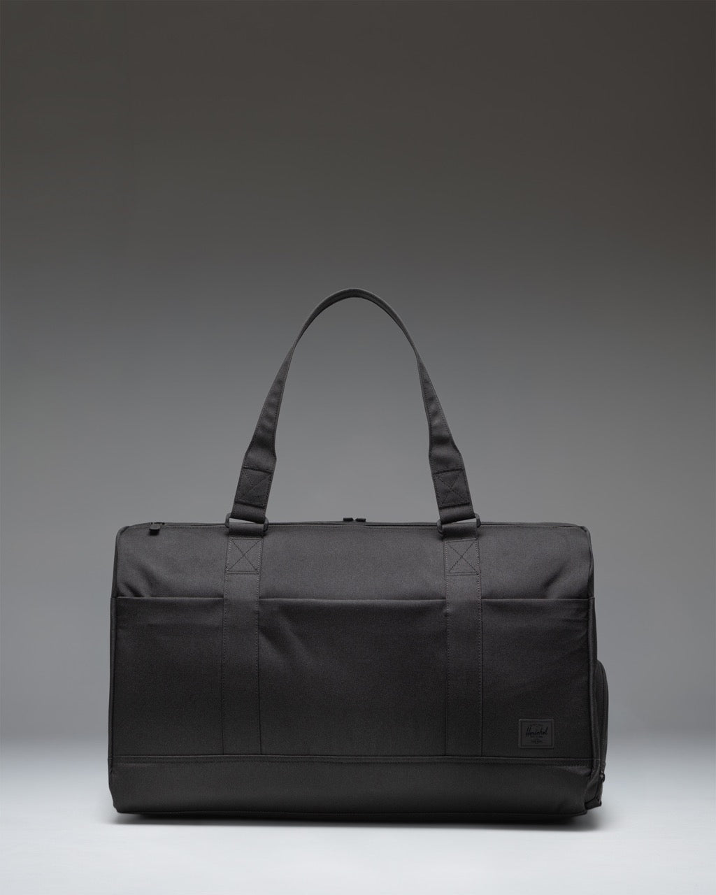 Black Herschel Novel Duffle Tech duffle bag, ideal for travel and tech storage.