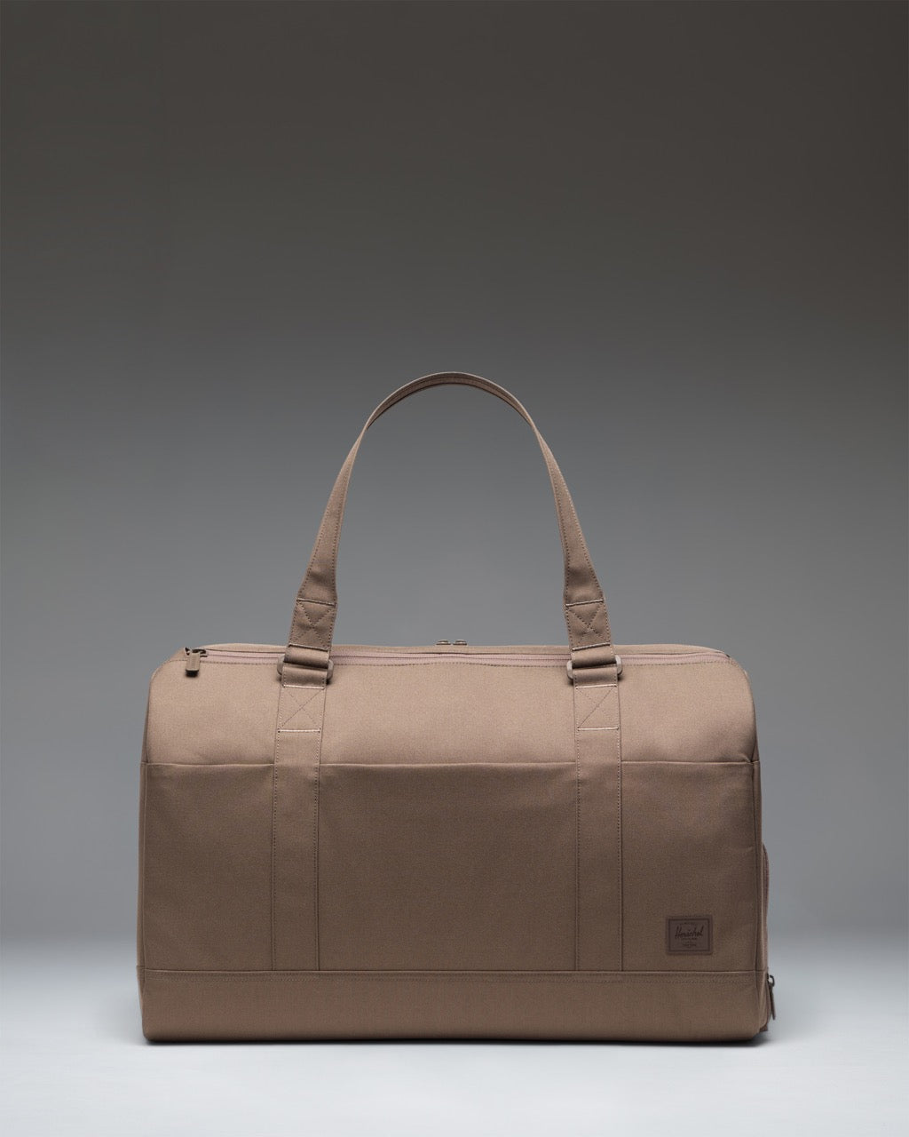 Herschel Novel Duffle Tech bag in light brown showing the spacious main compartment, separate shoe compartment, and durable carrying handles.