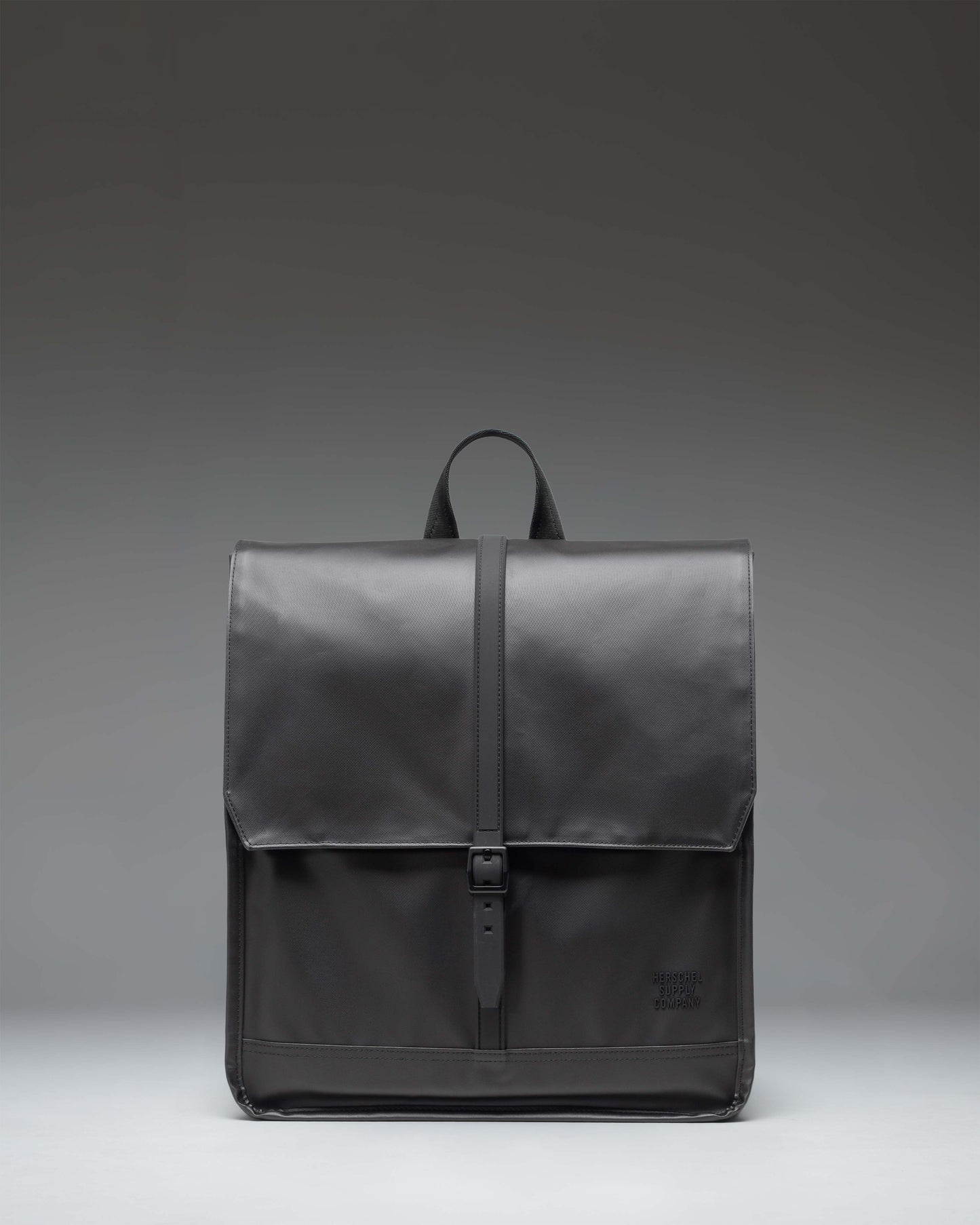 Herschel Supply Co City Backpack in black, showcasing a minimalist design with a single strap closure and a clean, modern aesthetic.