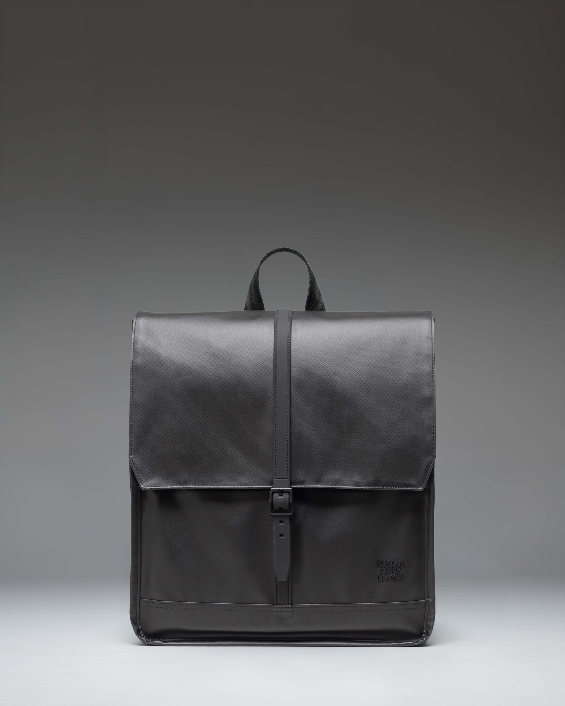Herschel Supply Co City Backpack in black, showcasing a minimalist design with a single strap closure and a clean, modern aesthetic.