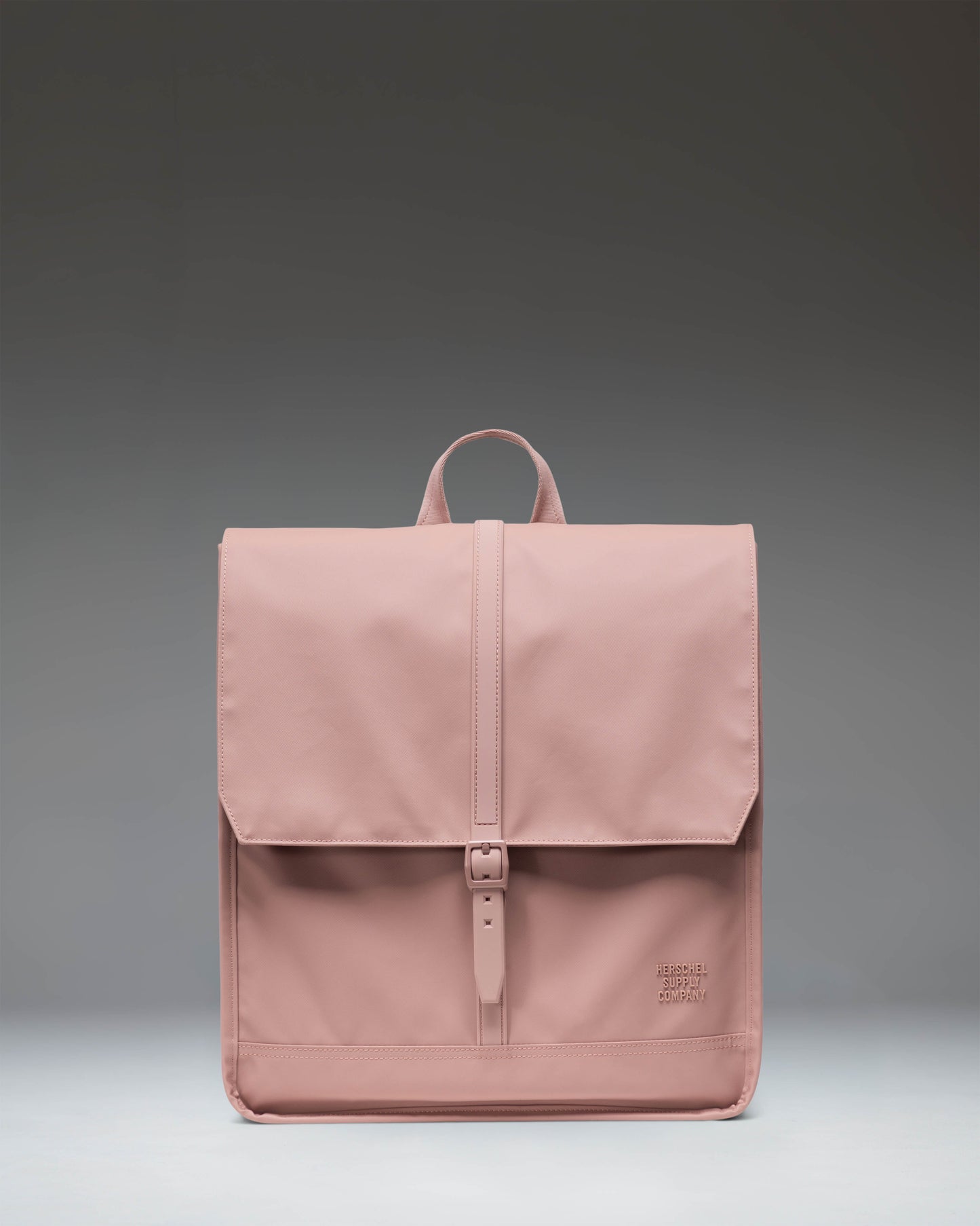 Herschel Supply Co. City Backpack in Ash Rose, a minimalist pink daily backpack with a clean design, single strap closure, and front storage sleeve.