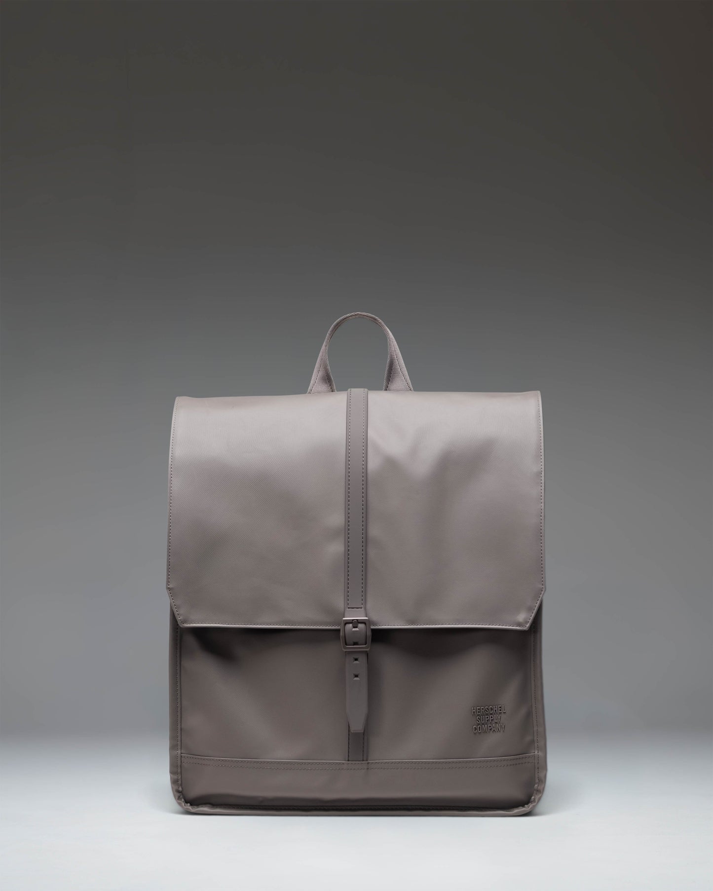 Herschel Supply Co. City Backpack in Dark Gull Gray shown from a front angle, featuring a clean design with a single strap closure.