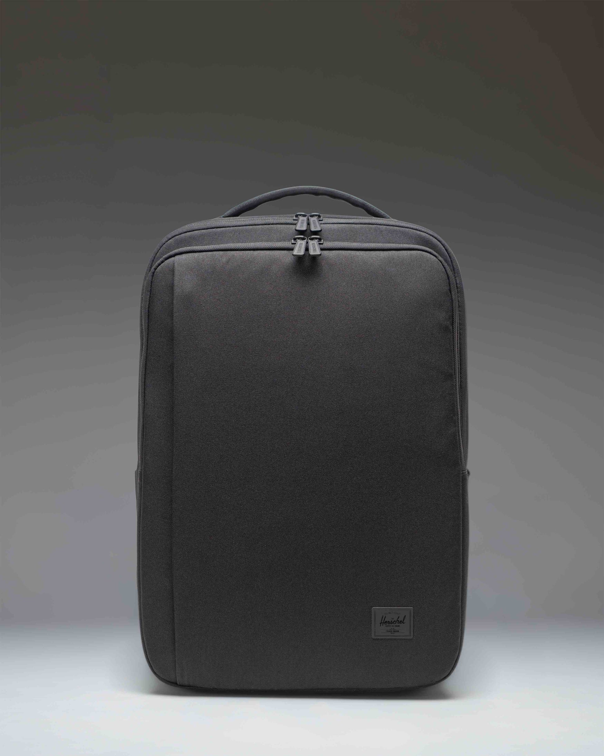 Herschel Supply Co. Kaslo Travel Backpack Tech in black. Clean front view showcasing the durable material and zippered compartments.