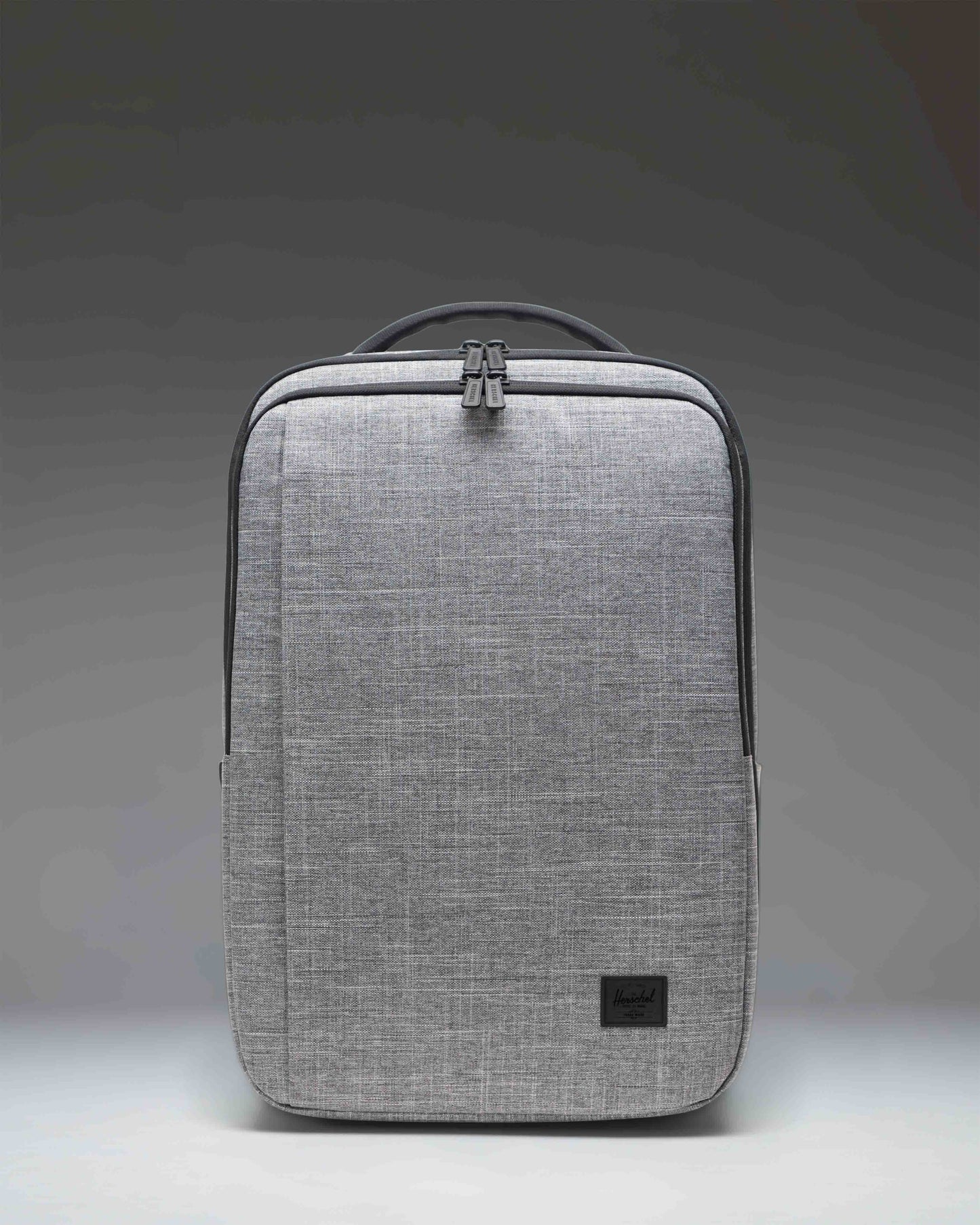 Front view of the Herschel Kaslo Travel Backpack Tech in Raven Crosshatch, featuring a textured grey design with multiple zippered compartments.