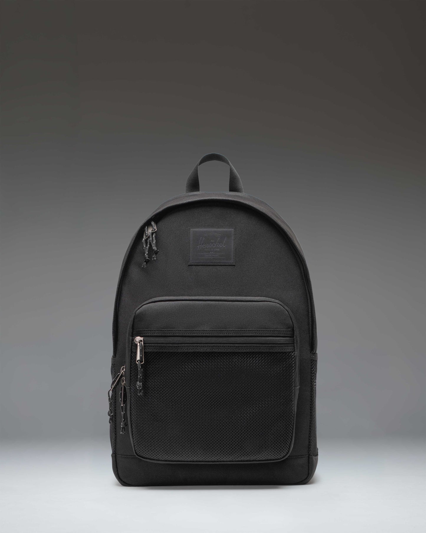 Herschel Supply Co. Kaine Backpack in black, featuring a front storage pocket, side water bottle pockets, and adjustable shoulder straps.