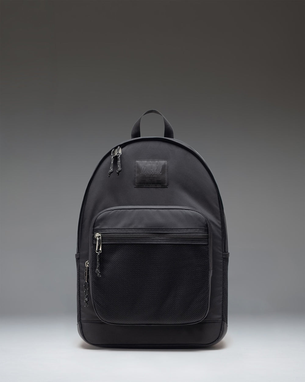 Herschel Supply Co. Kaine Backpack in black, showing the front view with zippered pockets and mesh side pockets.