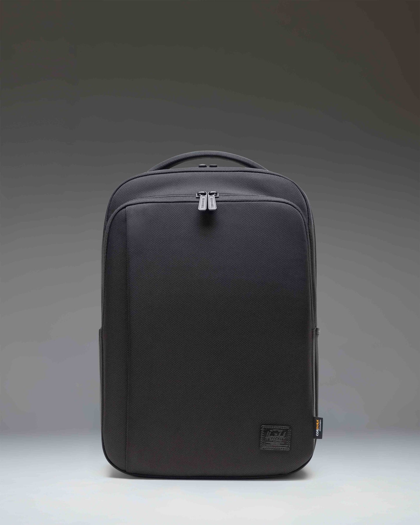 Herschel Supply Co. Kaslo Daypack Tech Cordura in black, shown from the front highlighting its clean design, zippers, and durable material.