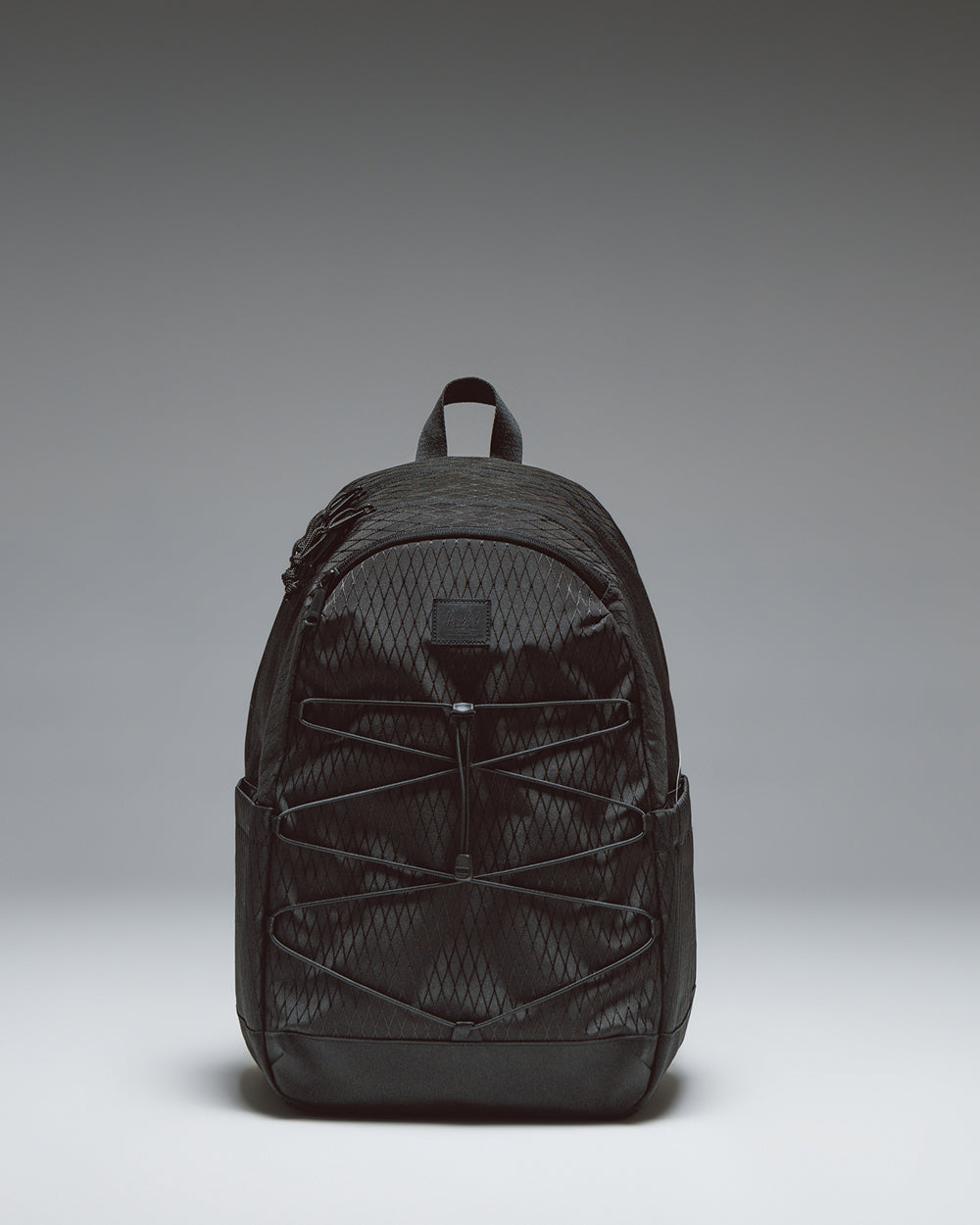 Herschel Kingston Backpack in Black Diamond/Black featuring a sporty silhouette, a front bungee cord system, and adjustable shoulder straps.