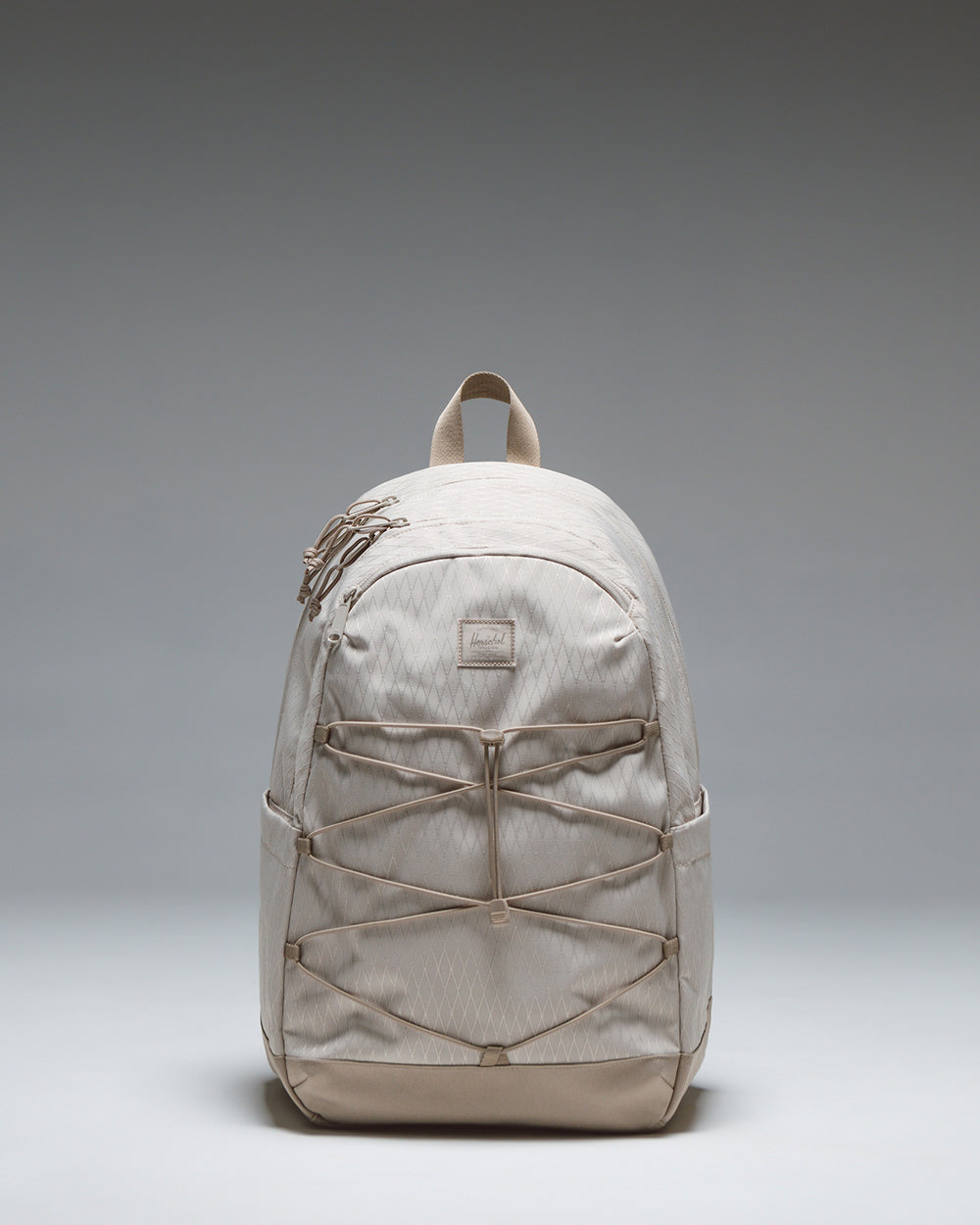 Herschel Supply Co. Kingston Backpack in French Oak Diamond/Cobblestone showing its athletic silhouette and front bungee cord system.