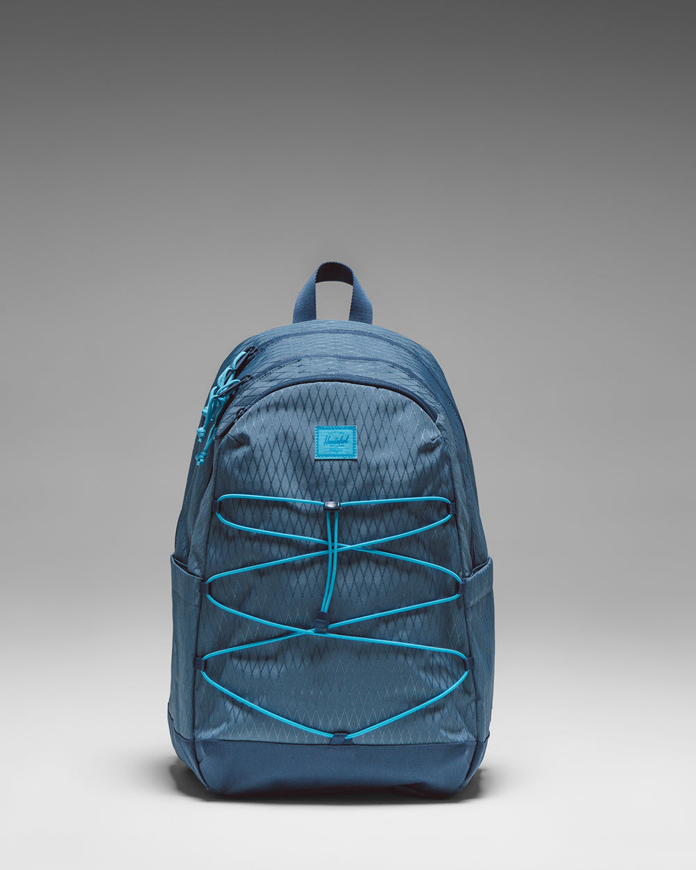 Herschel Kingston Backpack in Bering Sea Diamond and Dark Denim, featuring a patterned blue and solid dark blue design.