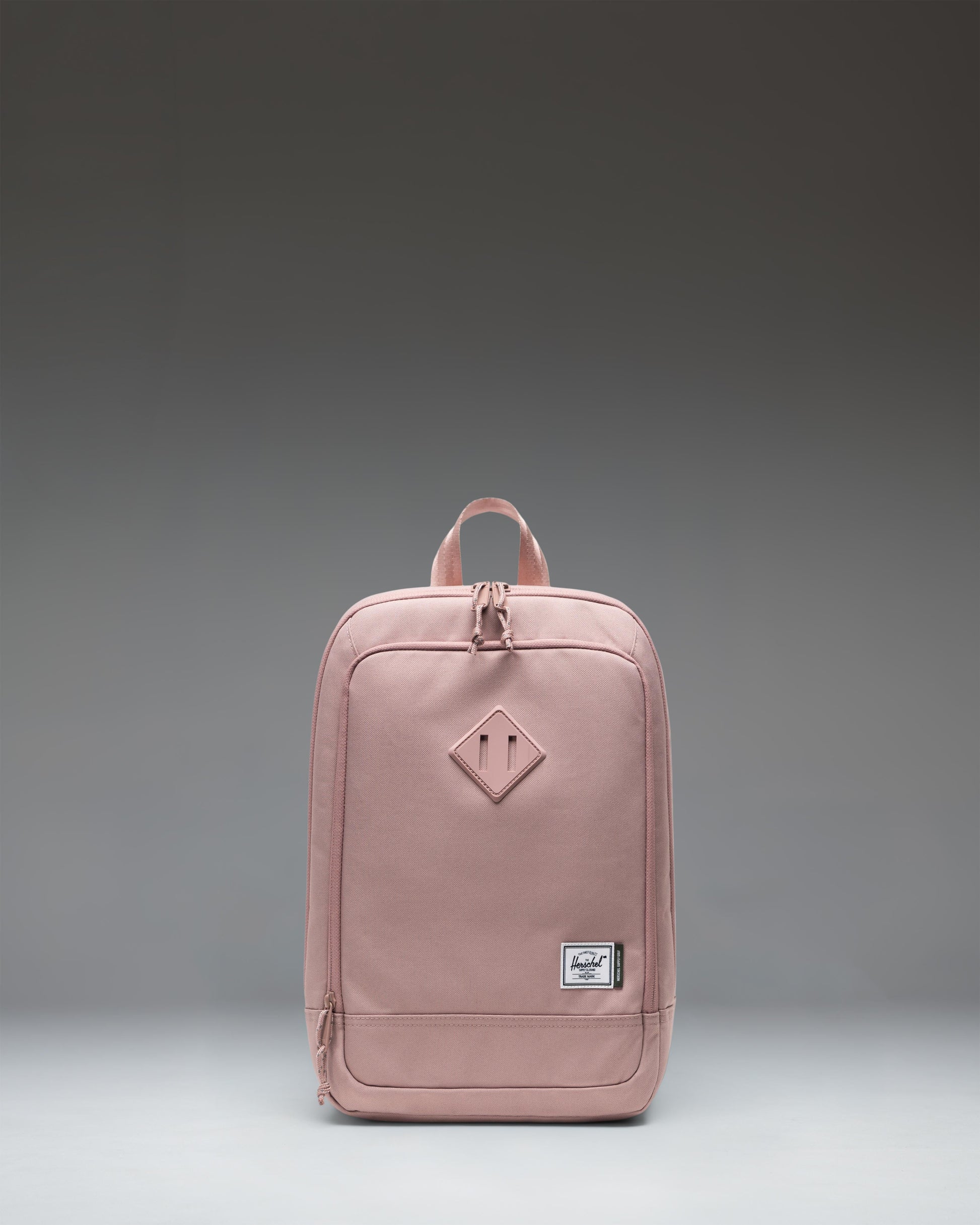 Herschel Heritage Shoe Bag in Ash Rose pink, featuring a main zipper closure, a convenient side handle, and the classic Herschel woven label.