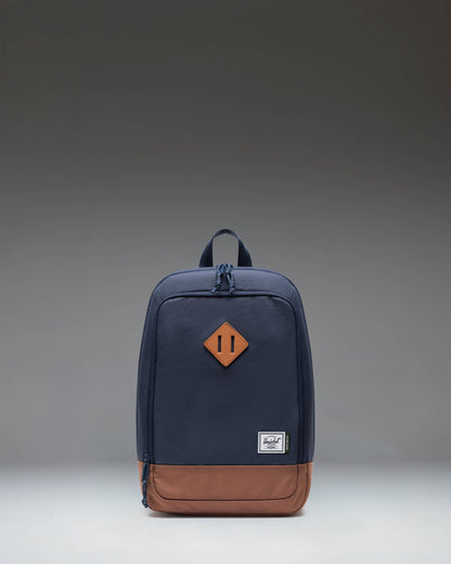 Herschel Heritage Shoe Bag in Navy Blue with a Saddle Brown leather base, featuring a carrying handle and the classic woven label.