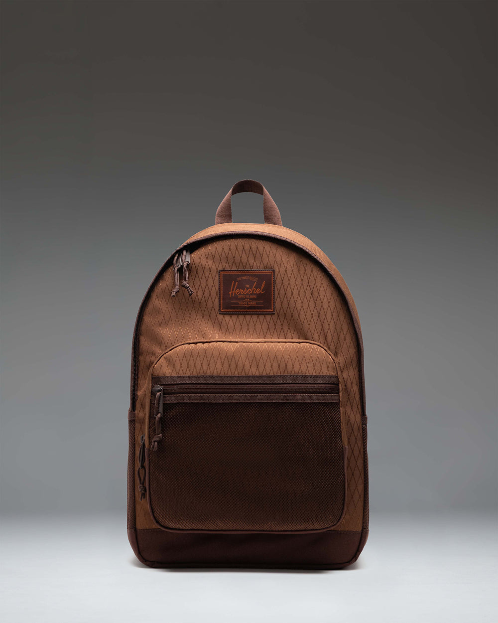 Herschel Supply Co. Kaine Backpack in Soft Silt Diamond/Chicory Coffee shown from the front, highlighting its multi-pocket design and utility straps.