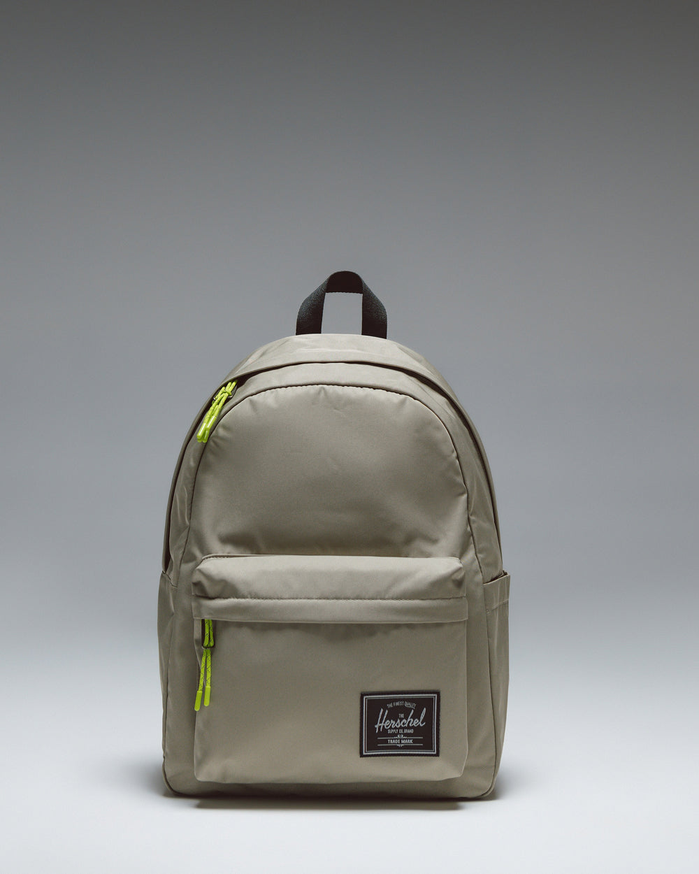 Herschel Classic Backpack Twill in Laurel Oak, showing the clean front design with a zippered pocket and woven label.