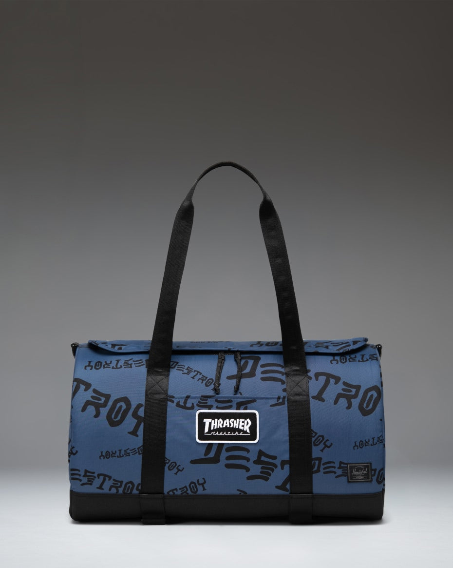 Herschel Heritage Skate Duffle Nylon in Oceana and Dark Navy Destroy, showing the durable design, skate straps, and Thrasher logo detailing.