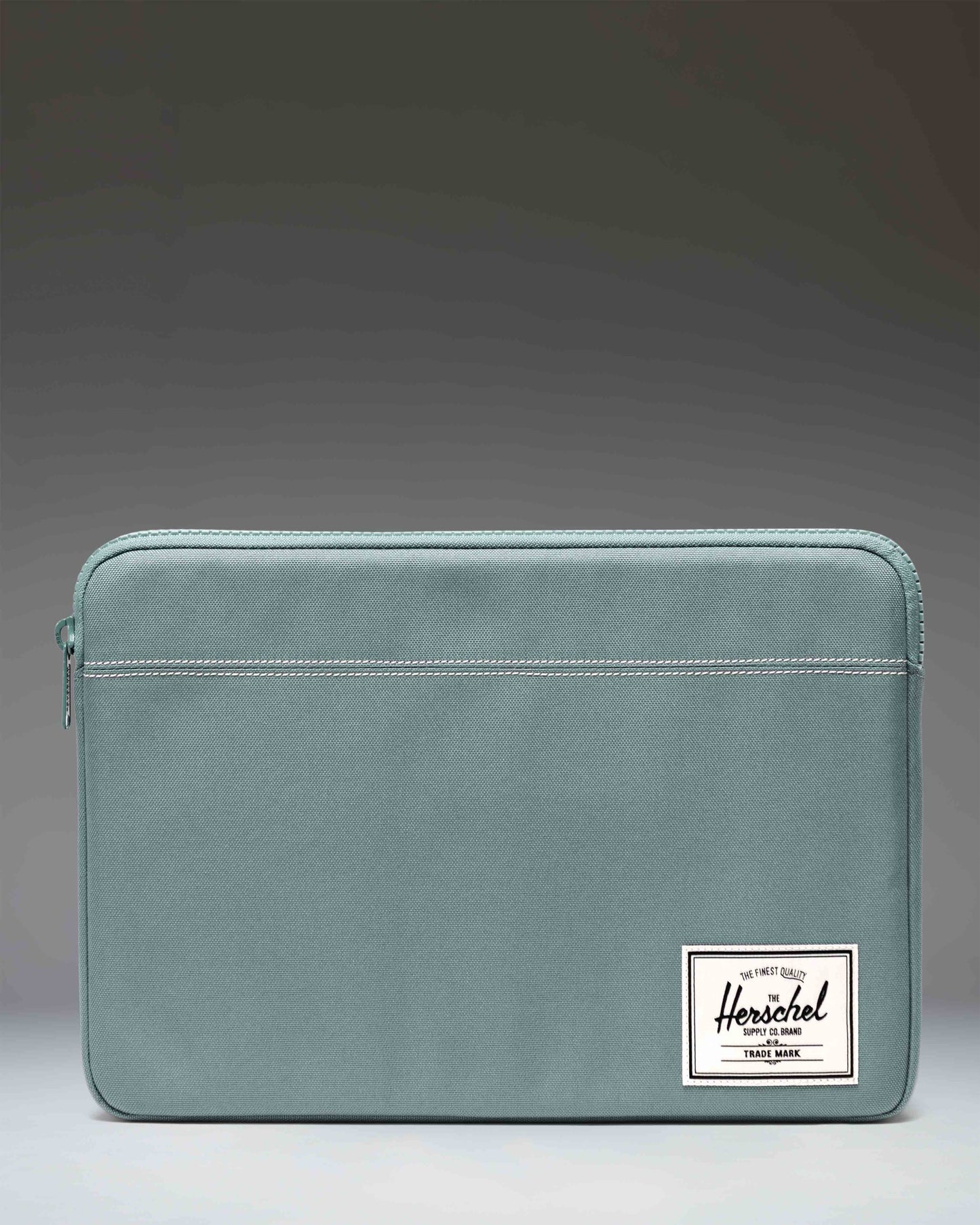 Herschel Supply Co. Anchor 14 Inch Sleeve in Realtree APX camouflage pattern, showcasing the padded and fleece-lined laptop case.