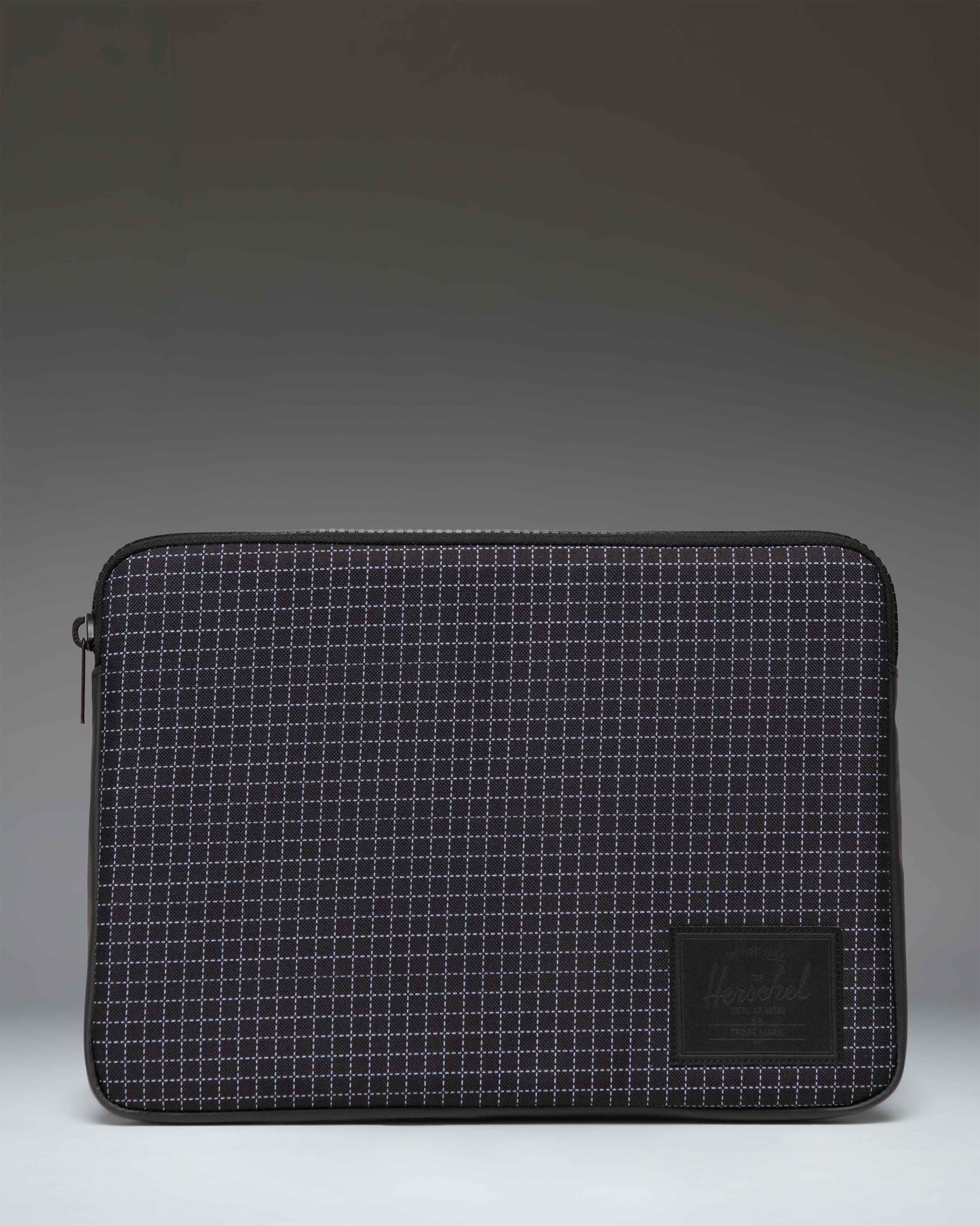 Herschel Supply Co. Anchor 14 Inch Sleeve in Grid Black/Black, a padded laptop sleeve with a grid pattern and classic logo label.