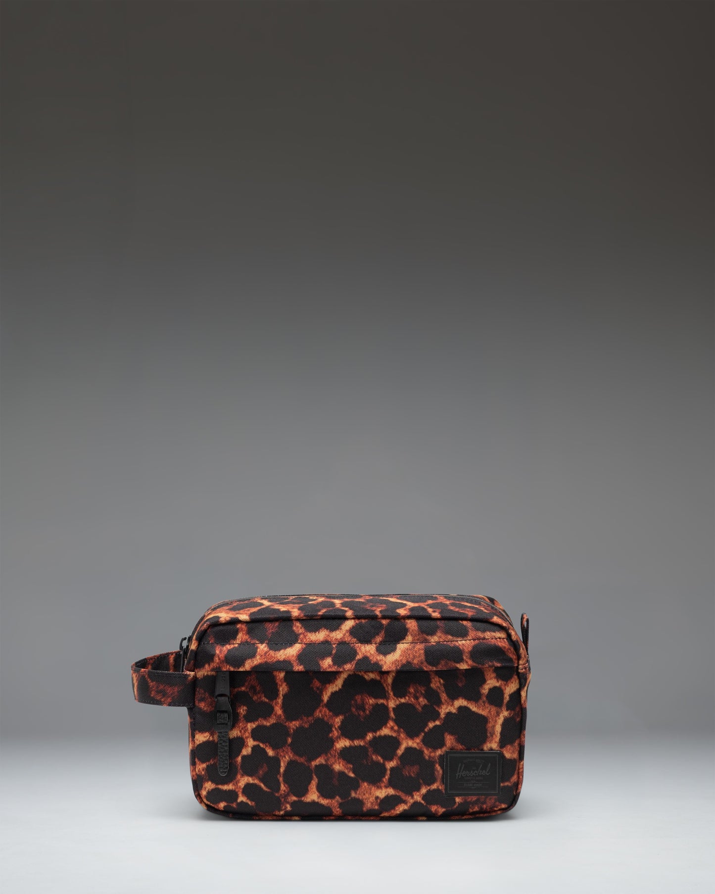 Herschel Supply Co. Chapter Travel Kit in Digi Leopard print, featuring a black leopard spot pattern on a grey background.