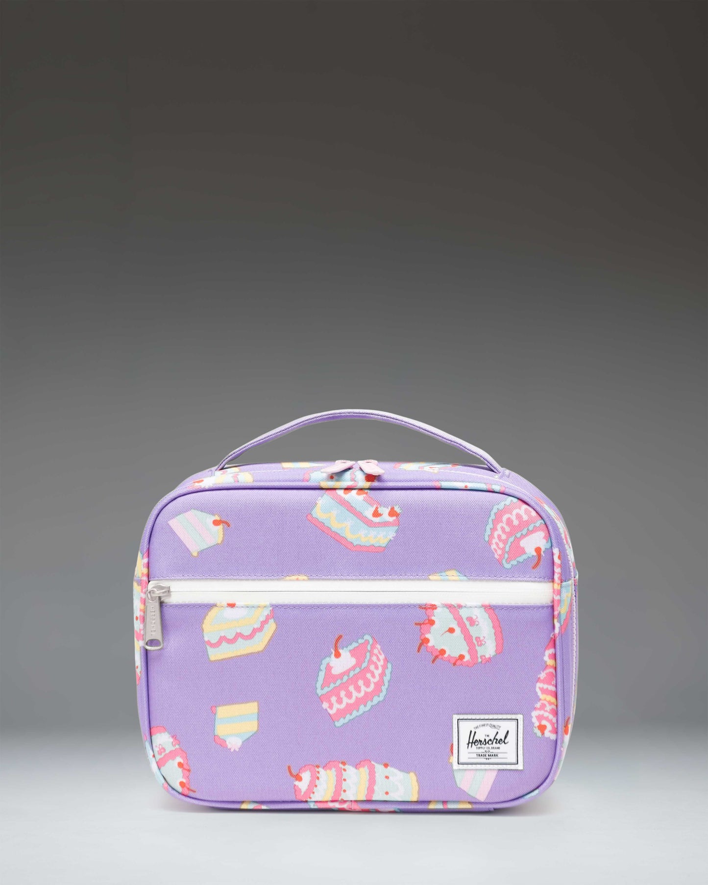Herschel Supply Co. Pop Quiz Lunch Box Little Herschel in Cakes colorway, showing the front view of the light pink patterned lunch box.