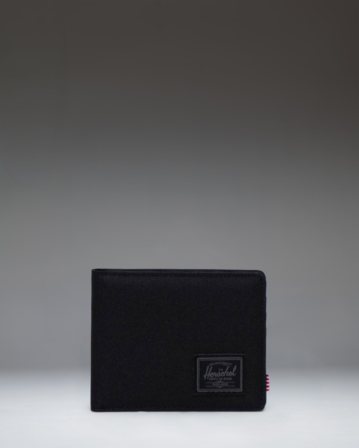 Herschel Supply Co. Roy Wallet in Black Tonal, showing the classic bi-fold design.